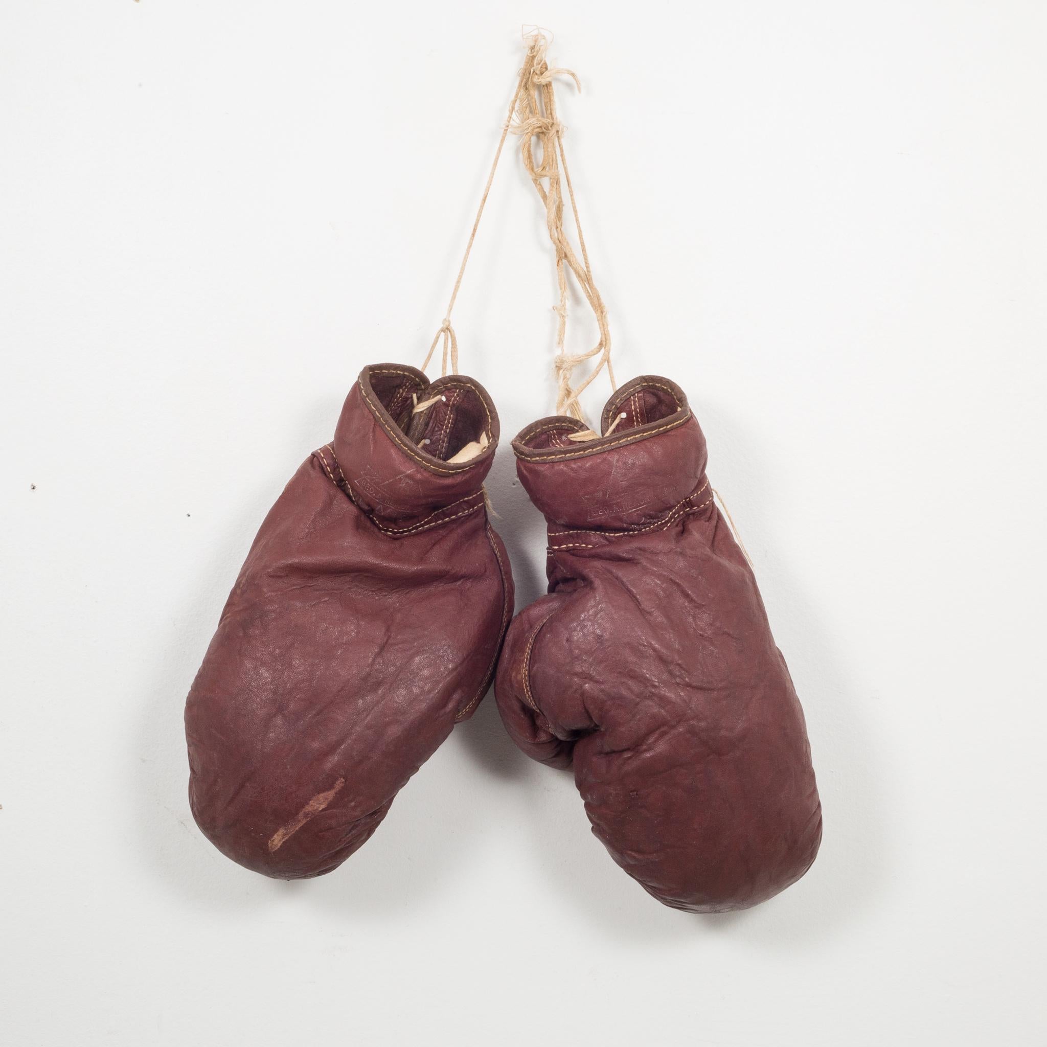 About

These are authentic vintage boxing gloves with reddish, brown leather filled with horse hair. Each glove has tan leather piping and tan laces. The leather is very soft and in good condition.

 Creator George A. Reach Co.
Date of