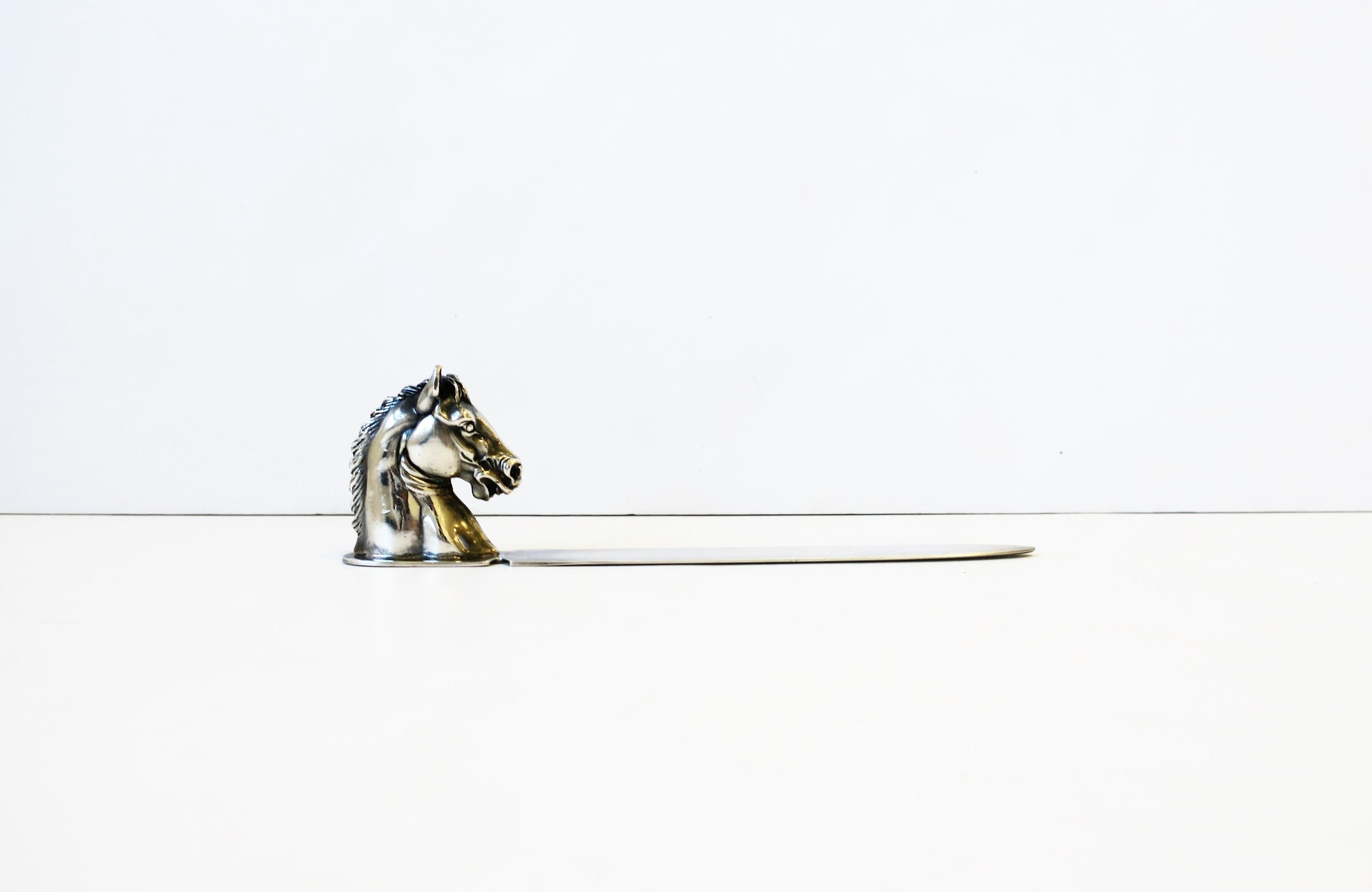 A substantial sterling silver plate letter opener with horse head handle made by Reed & Barton, circa mid-20th century, USA. A great desk, office, library, etc., accessory. With maker's mark on underside as shown in images #11 and 12. Dimensions: 1