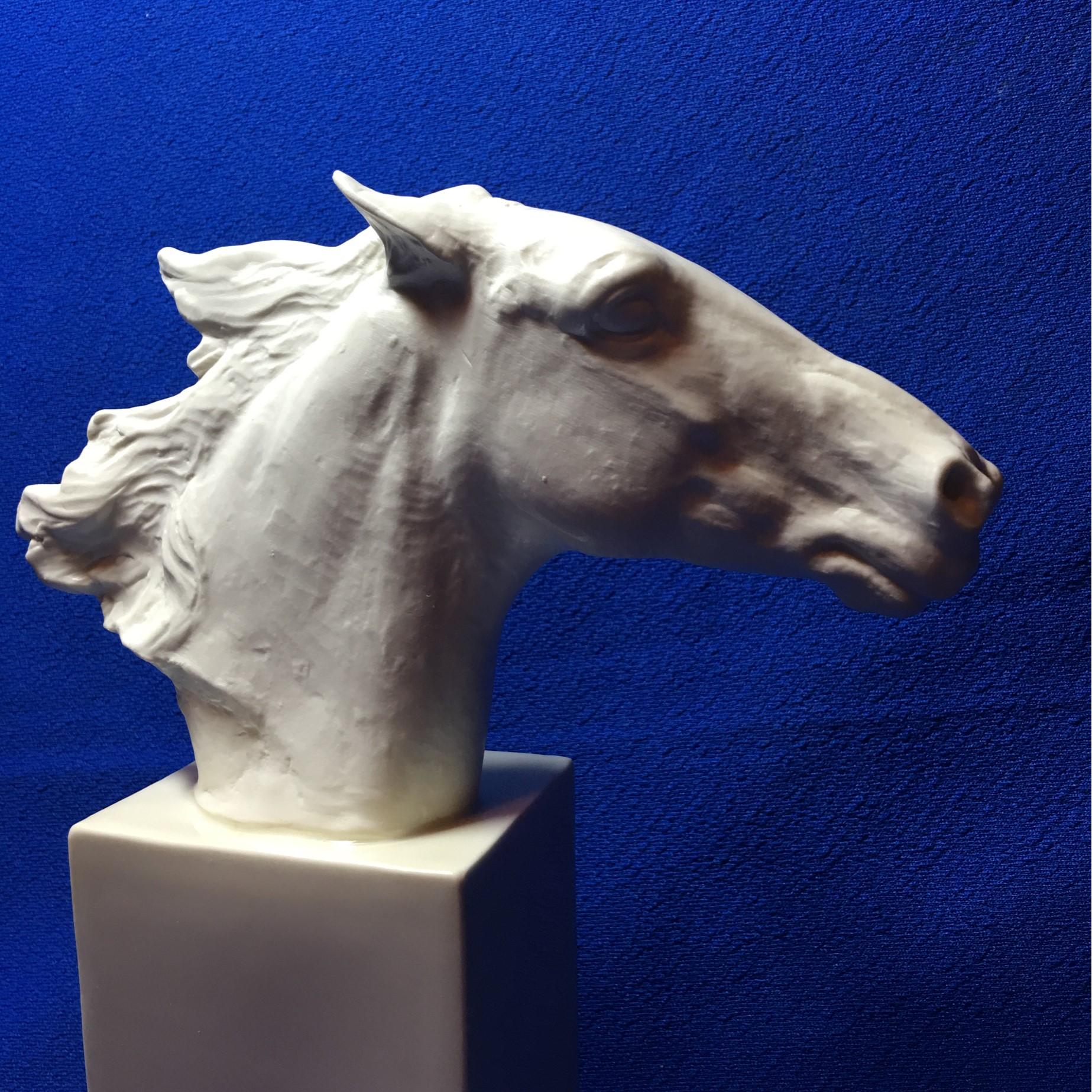 A beautiful horse head statue made of matted porcelain attached to a glazed porcelain pedestal. Designed and crafted between 1935 and 1953. Designed by Albert Hinrich Hussman a German artist who was awarded the 
