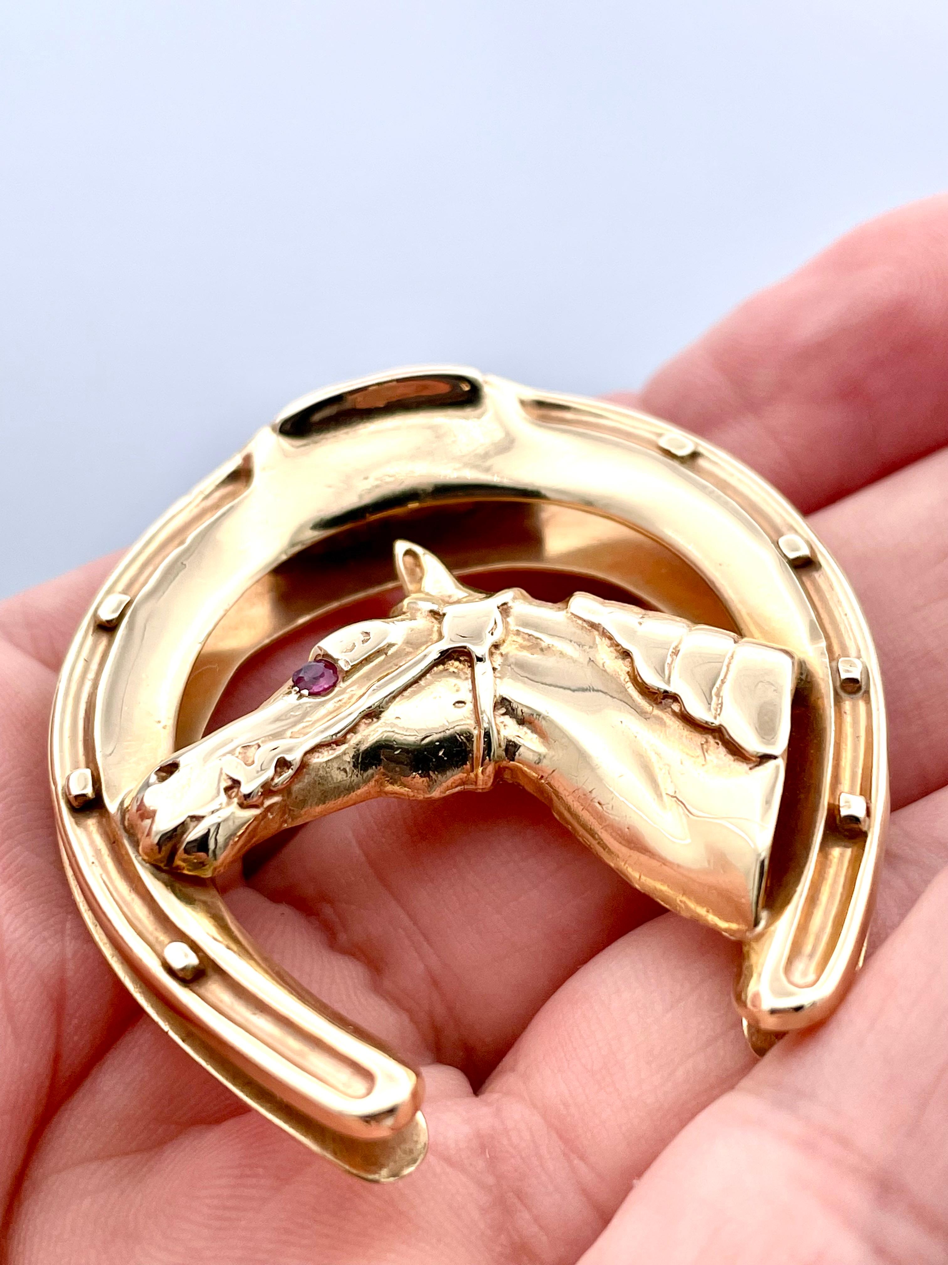 Great three-dimensional horse head money clip. Set within a large horse shoe.  The eye is set with a brilliant faceted ruby.  Very heavy gauge 14K yellow gold.  1 2/3