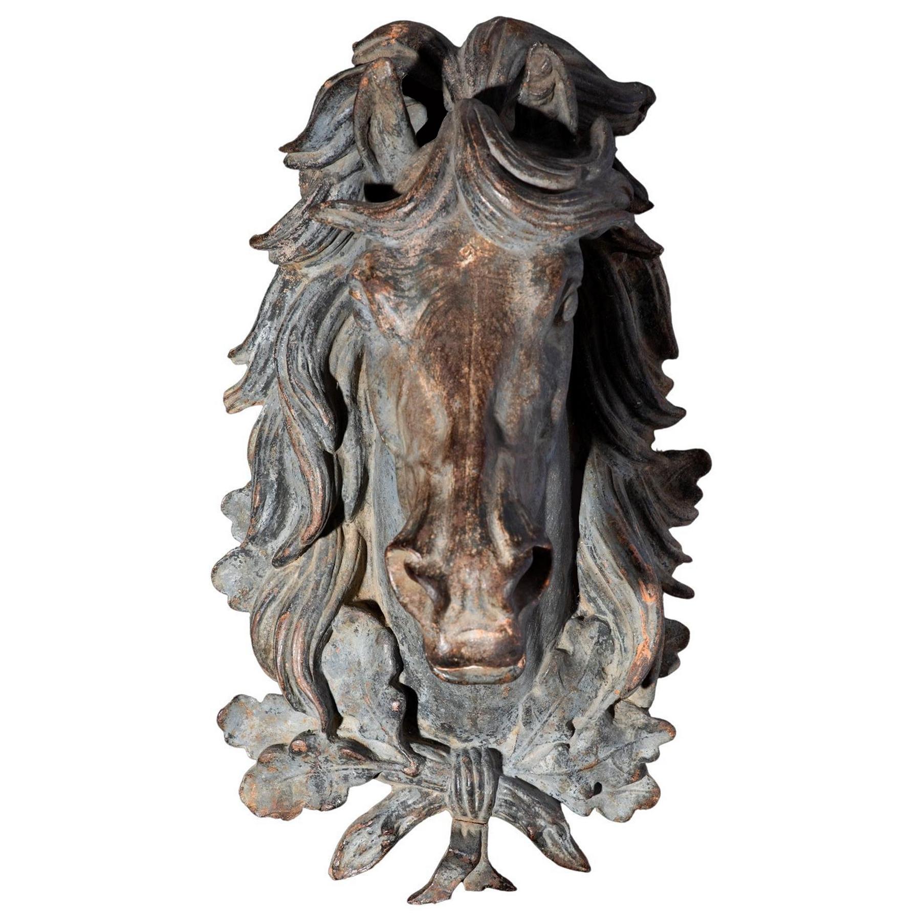 Very beautiful subject in cast iron representing a horse's head neighing, with the ears straightened, the mane provided and the dilated nostrils. He wears around his neck a ribbon knot decorated with oak leaves. 
This sculpture would have adorned