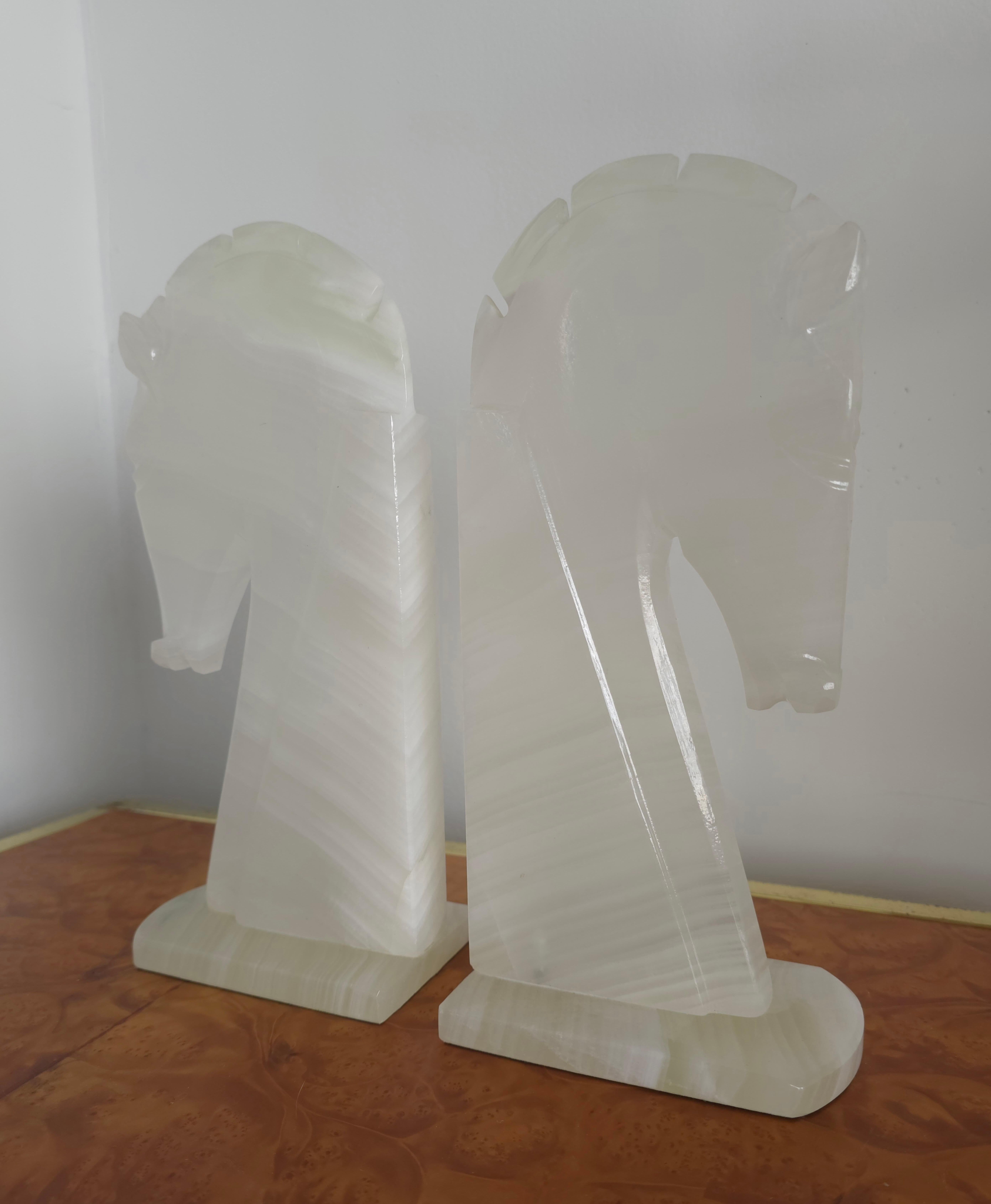 A pair of marble Stone bookends carved in the shape of a horse head. Made in the 1960s. This handcrafted horse head profile is made with onyx stone that is very light white in colour with some variation in tone throughout the veining of the marble.