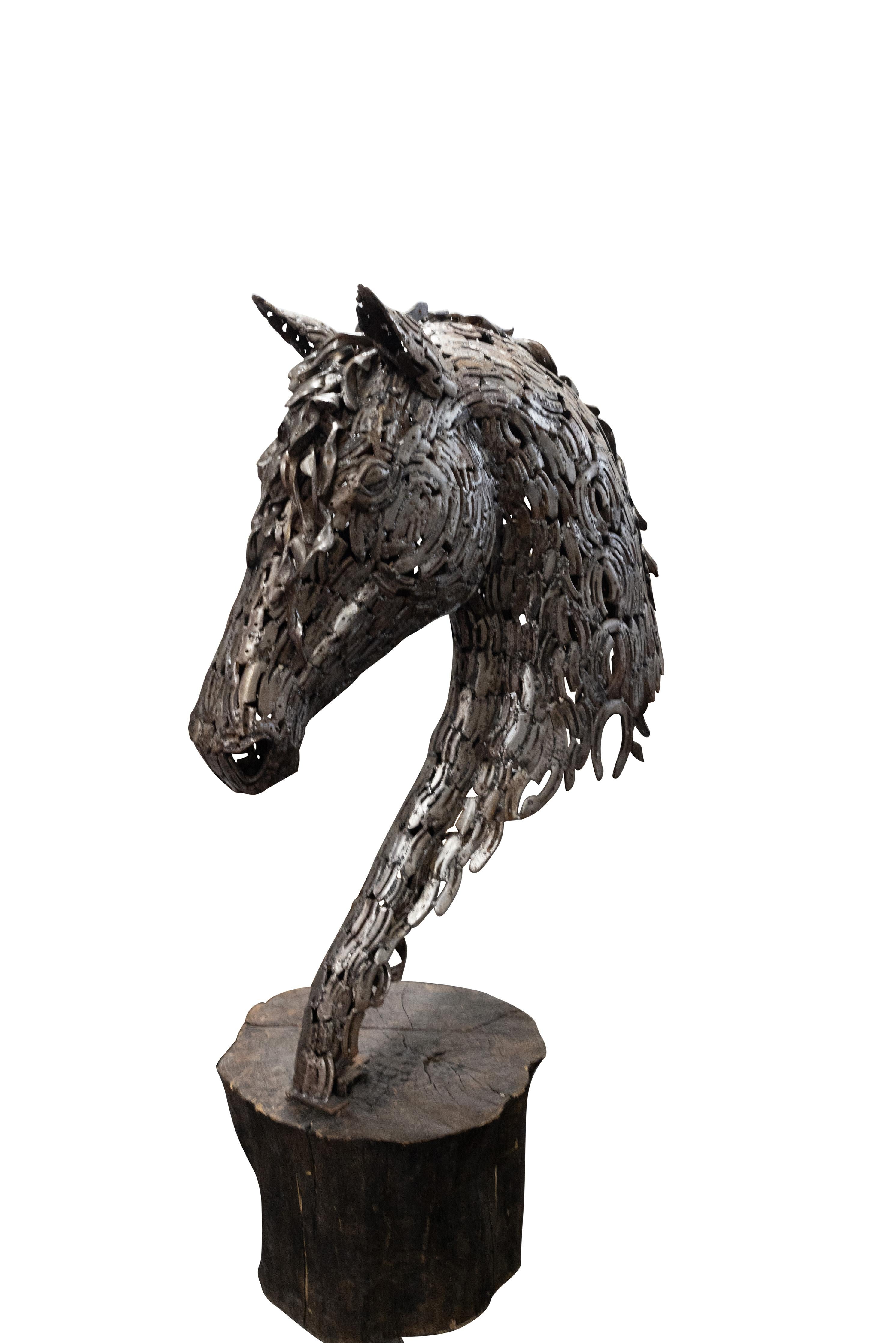 Horse Head Sculpture fashioned from Horseshoes with tree trunk base. Newly made.

Dimensions:

Base- 19 1/2