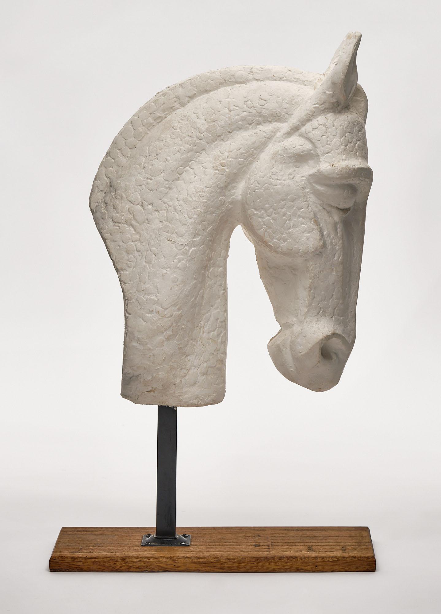 Horse head sculpture from France made of white plaster. This piece rests on an iron and natural wood stand.