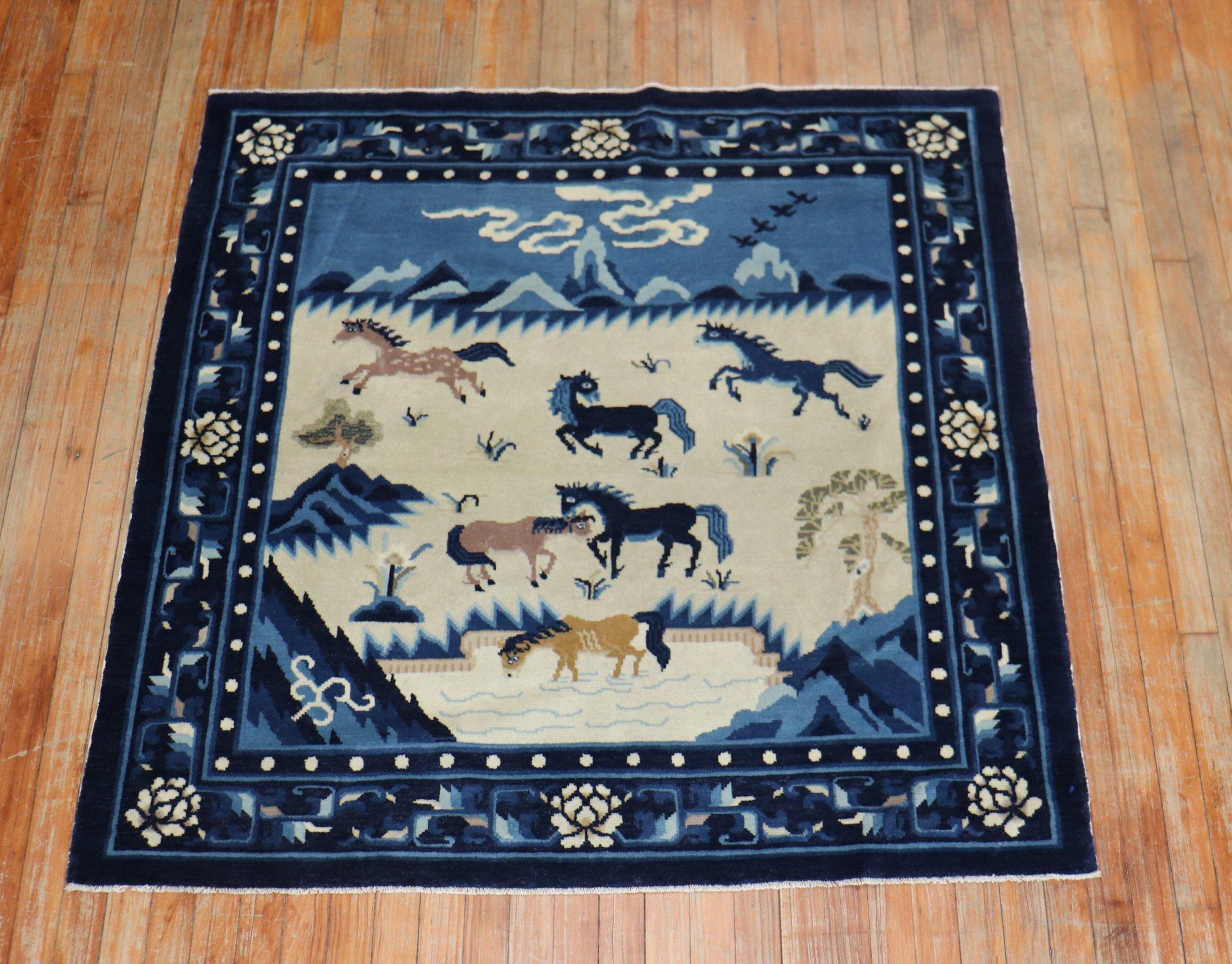 A mid-20th century conversational Chinese pictorial rug with a herd of horses on a beige field surrounded by a navy floral border.

Measures: 4'6