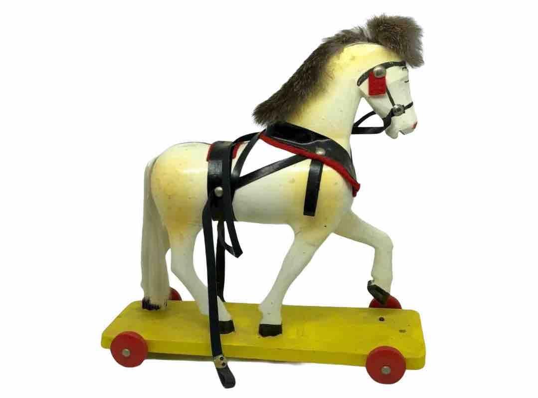 This old hand carved wooden horse on wooden wheels, was made in the Ore Mountains in Germany. It remains fully functional. Crafted in Germany during the 1950s. It is and painted and a very decorative piece for your home.


     