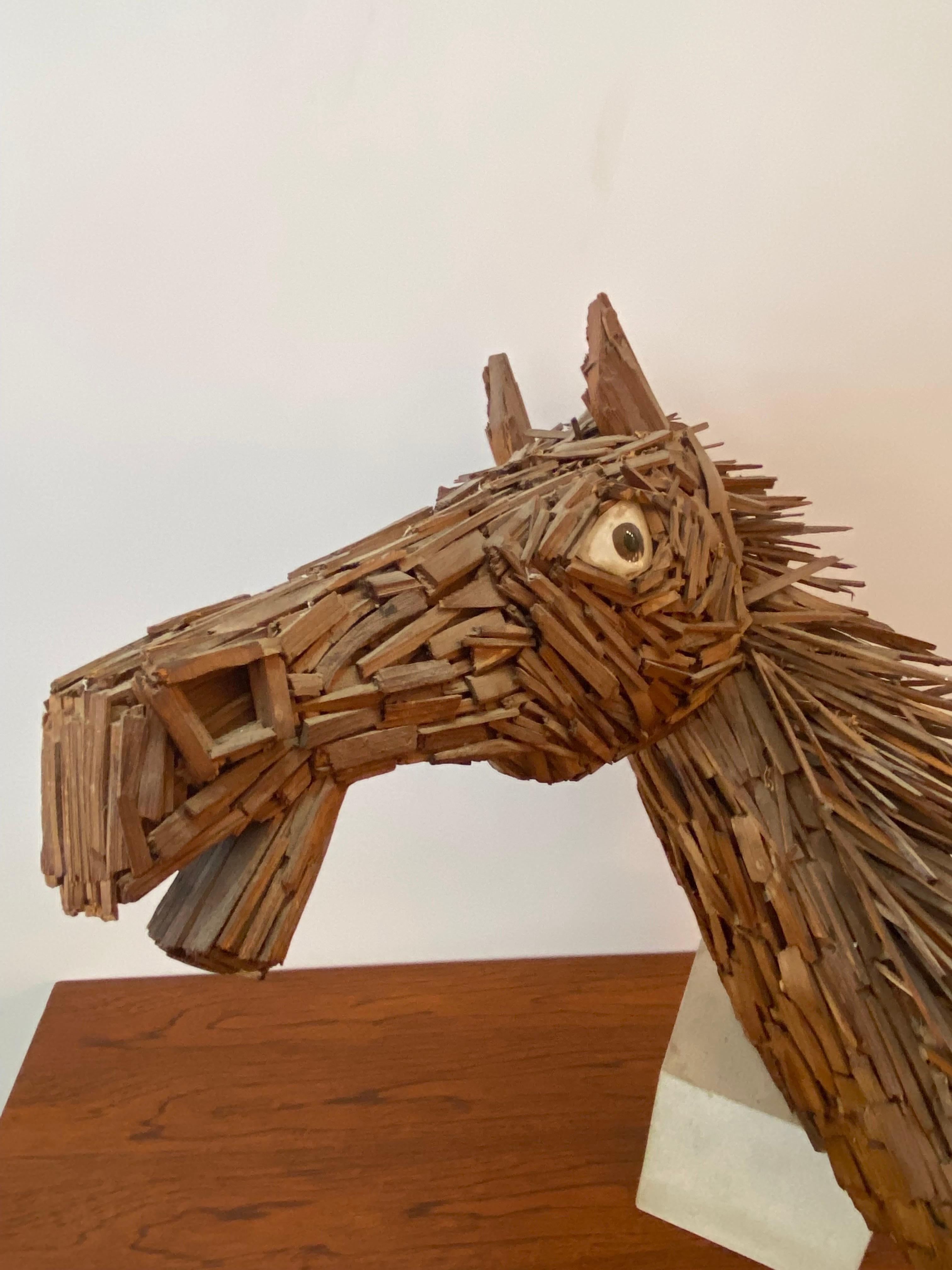 Horse Sculpture by Philadelphia Artist Theodore Miller, from the early 1970's Sculpture made up of cut scraps of wood, eyes are painted glass pieces. Sits on a Stone base. below price is an estimate from 1stdibs.