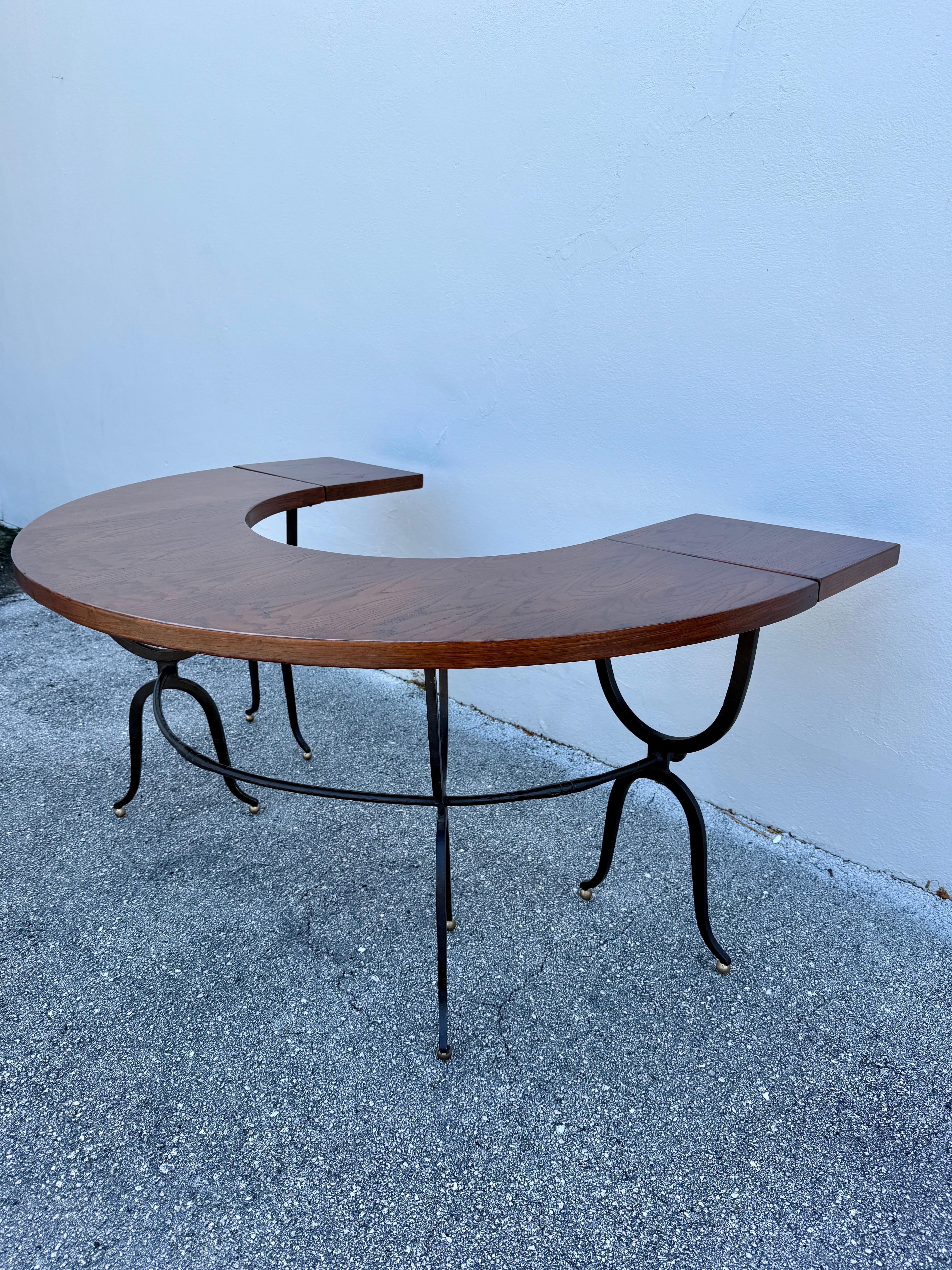 This Italian semi-circle table with drop leaves is perfect for a bar or desk.  The wrought iron base and legs with brass ball feet.  It is a wonderful piece with so much character.  NOTE: 33 inches deep when leaves are closed
