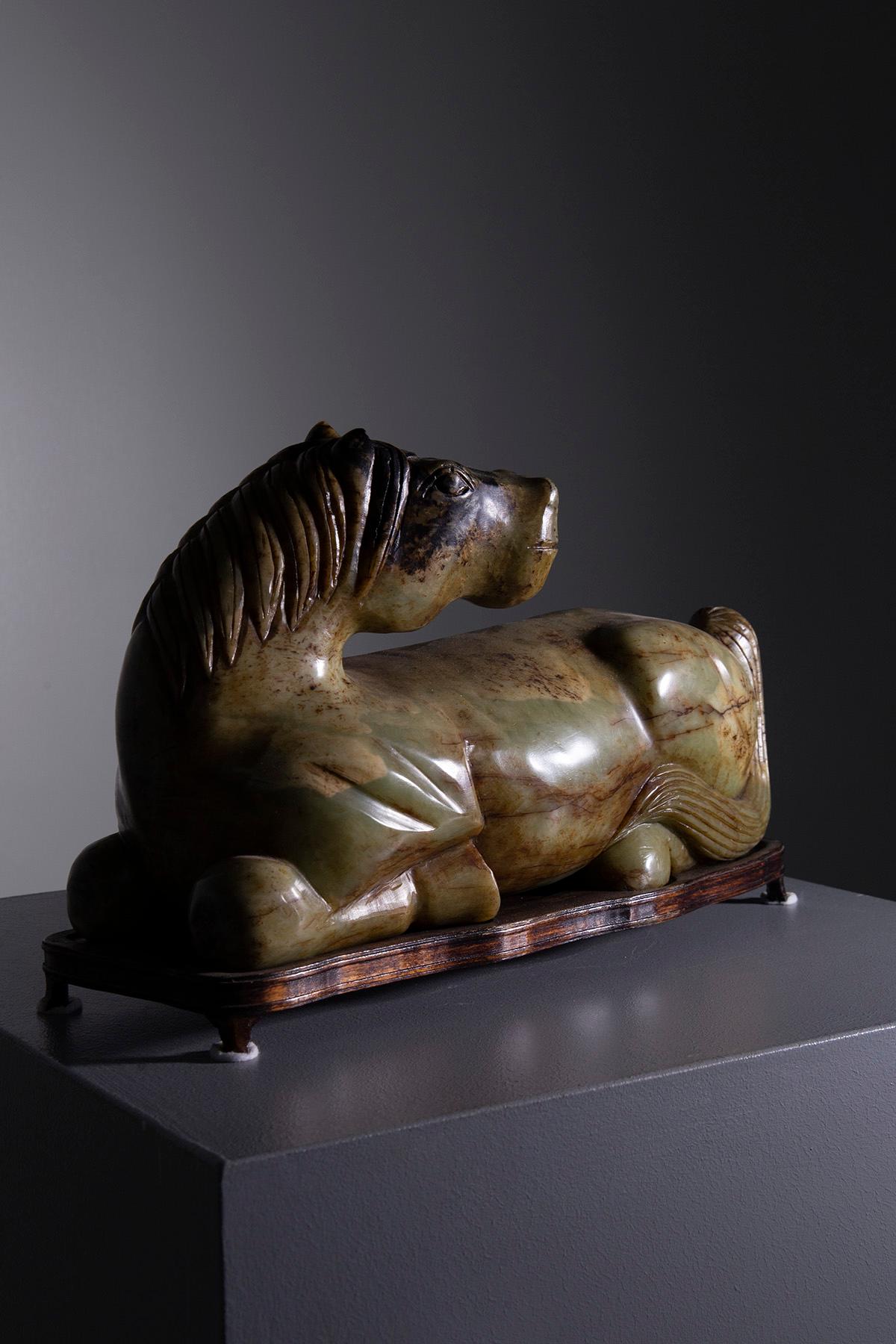 Discover the tranquil elegance of this green jade horse statuette, a splendid piece of craftsmanship that captures the essence and majesty of the equine form. Meticulously carved from exquisite jade, this sculpture radiates a serene translucence and