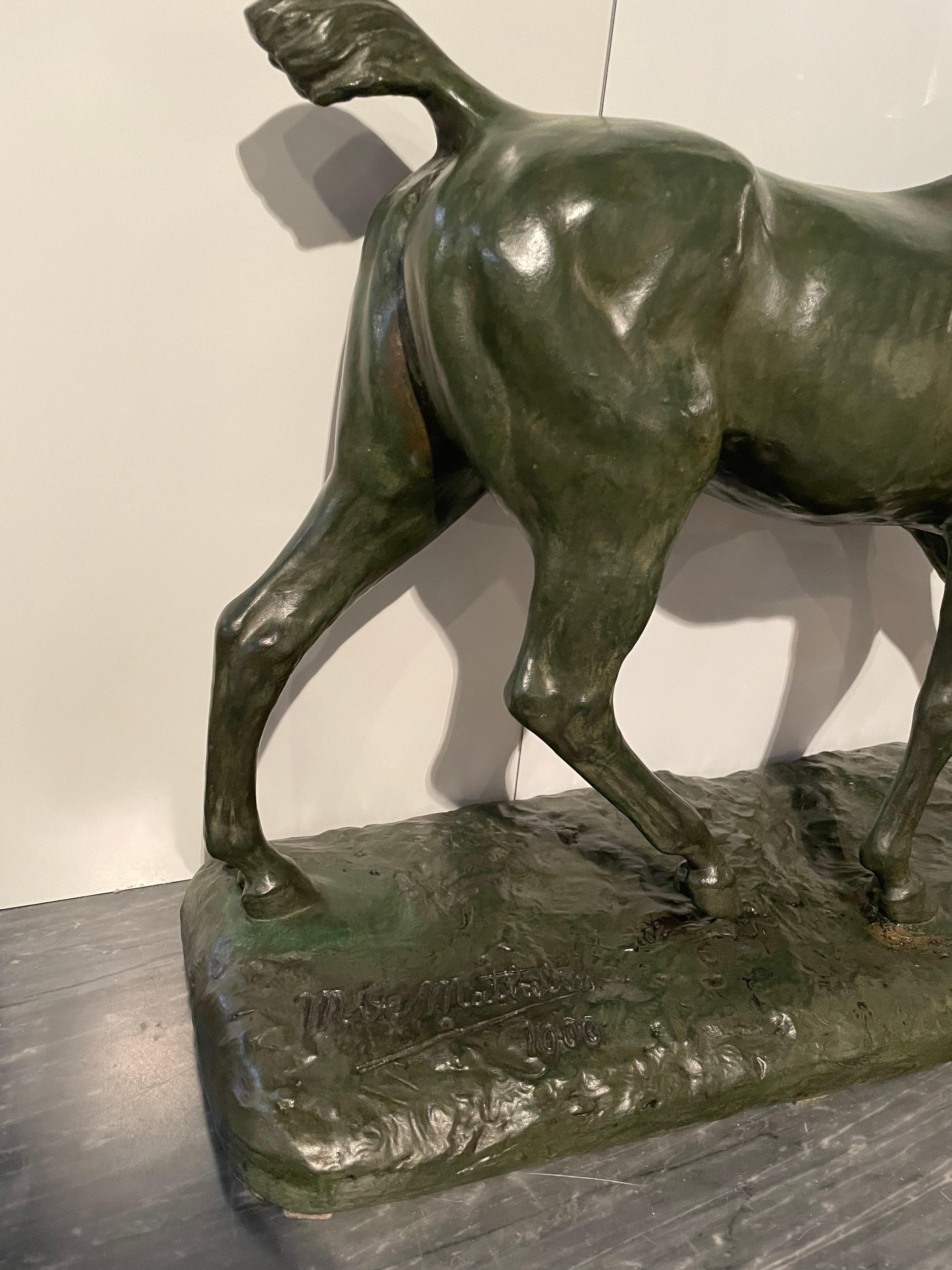 Belgian Horse walking in bronze with green patina. Signed on the base M.de Mathelin 1900 For Sale