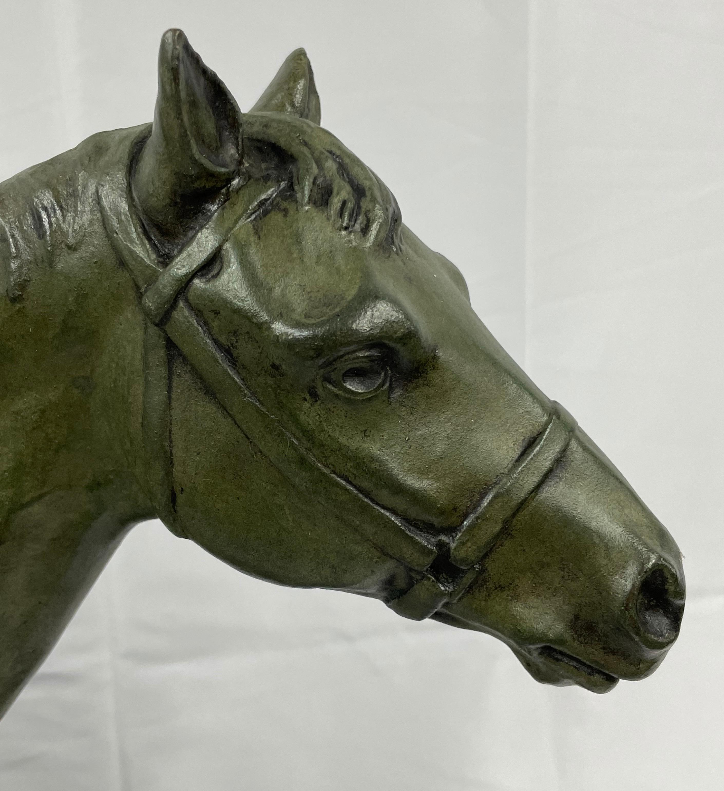 Bronze Horse walking in bronze with green patina. Signed on the base M.de Mathelin 1900 For Sale