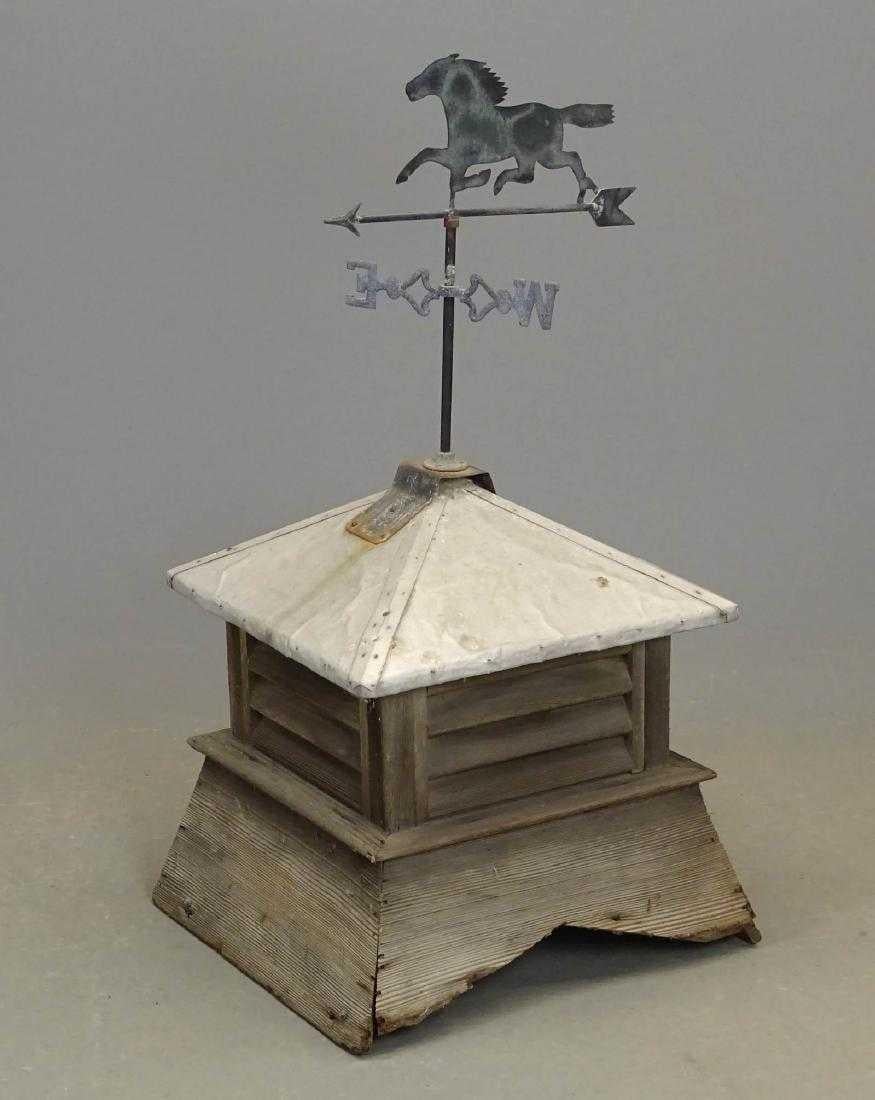 Great farmhouse antique sheet metal horse weathervane on wooden cupola.