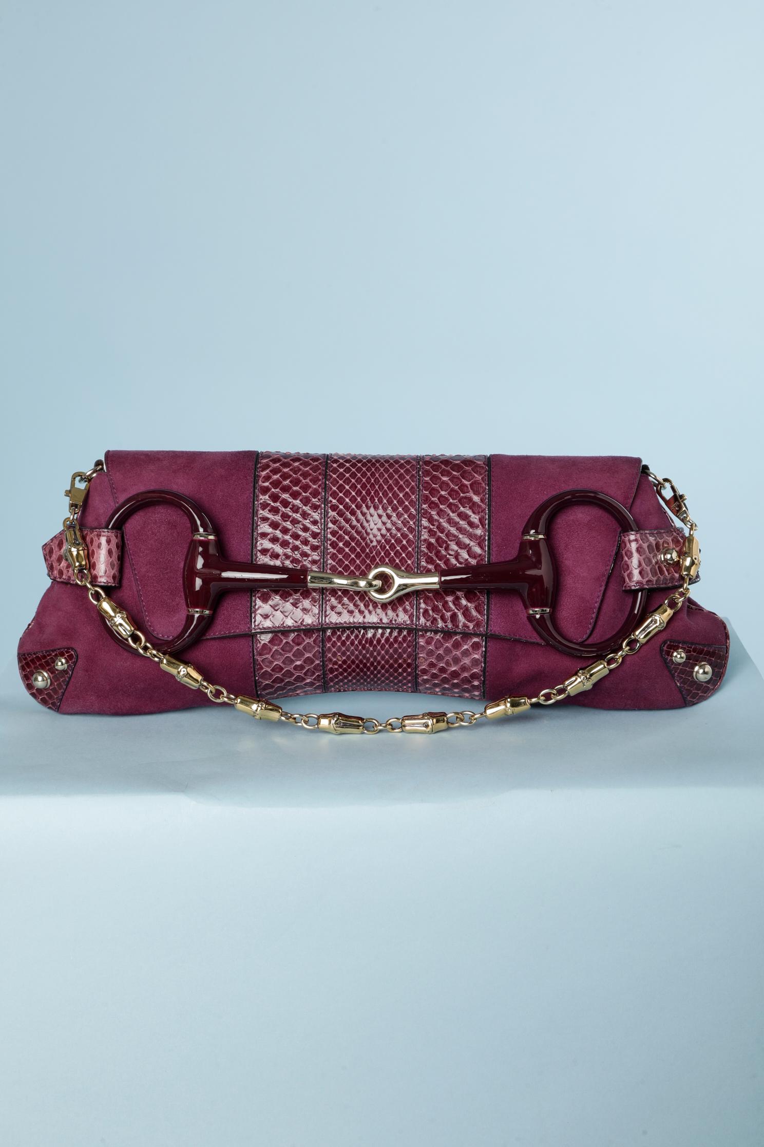 Horsebit purple suede and python chain clutch bag . The lining is in purple satin and burgundy leather. Size: 38 cm X 15 cm