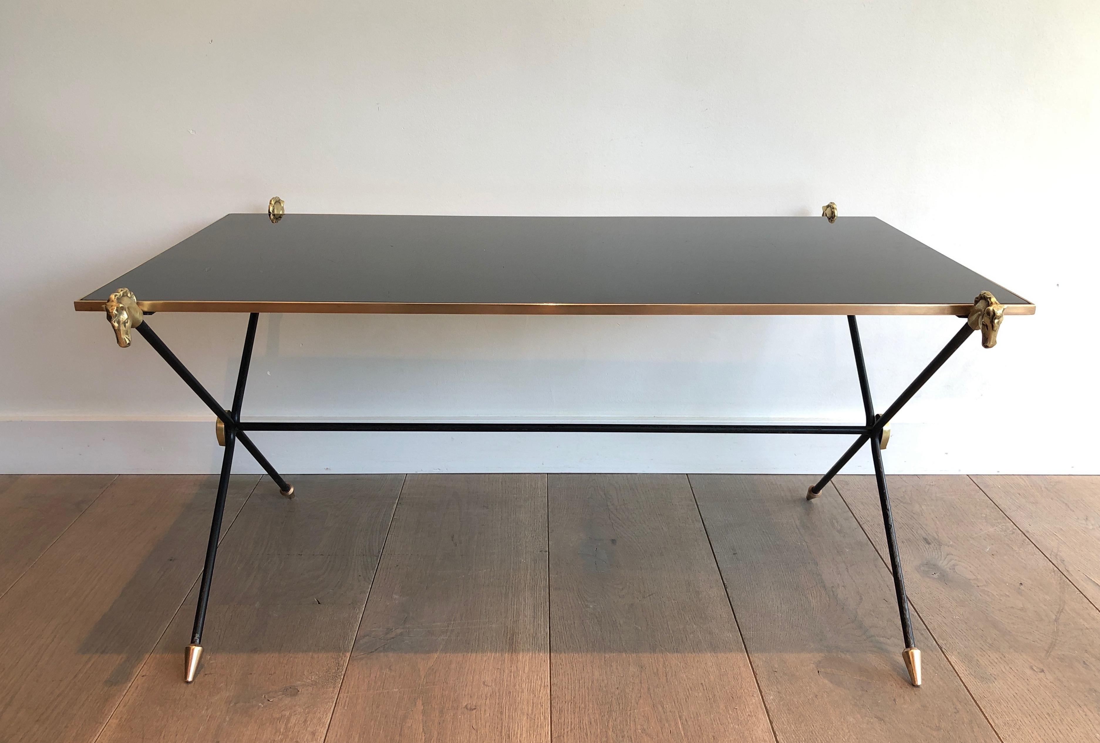 This coffee table is made of black lacquered metal with brass horseheads,  horseshoes and feet. This is a work by famous French designer Maison Jansen. Circa 1940
