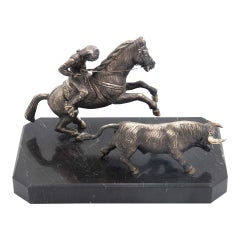 Horseman on horseback driving a bull