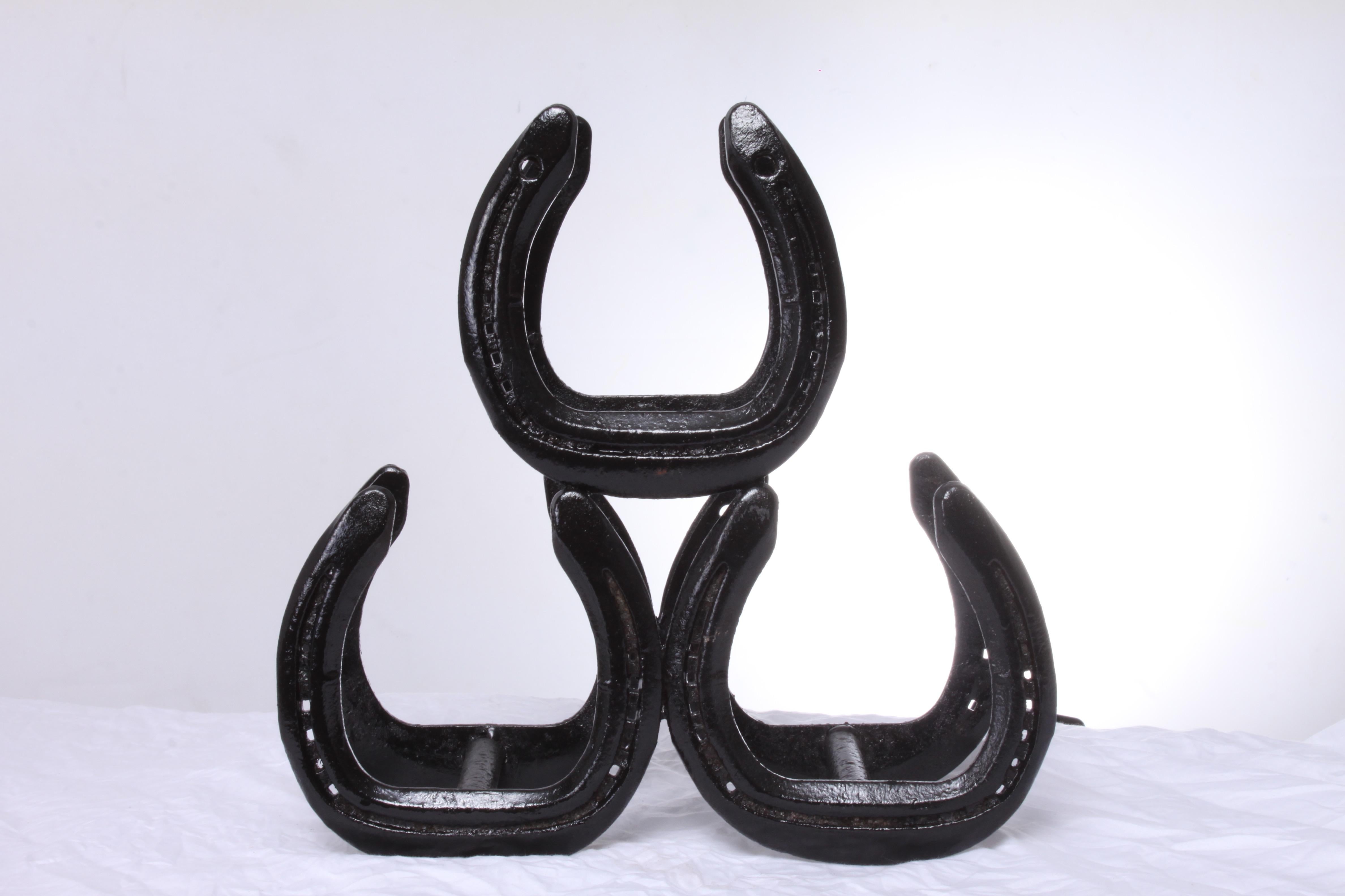 Horseshoe 3 bottle metal wine rack (black finish) 
A handmade totally from recycled materials using real horseshoes. This can hold three wine bottles.