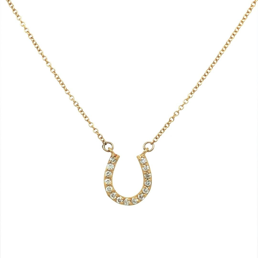 This classic charm pendant features a horse shoe embellished with 15 glittering round brilliant cut diamonds weighing approximately 0.25 carat total weight. A sparkling symbol of good luck, this horseshoe pendant with diamonds is crafted in 14k