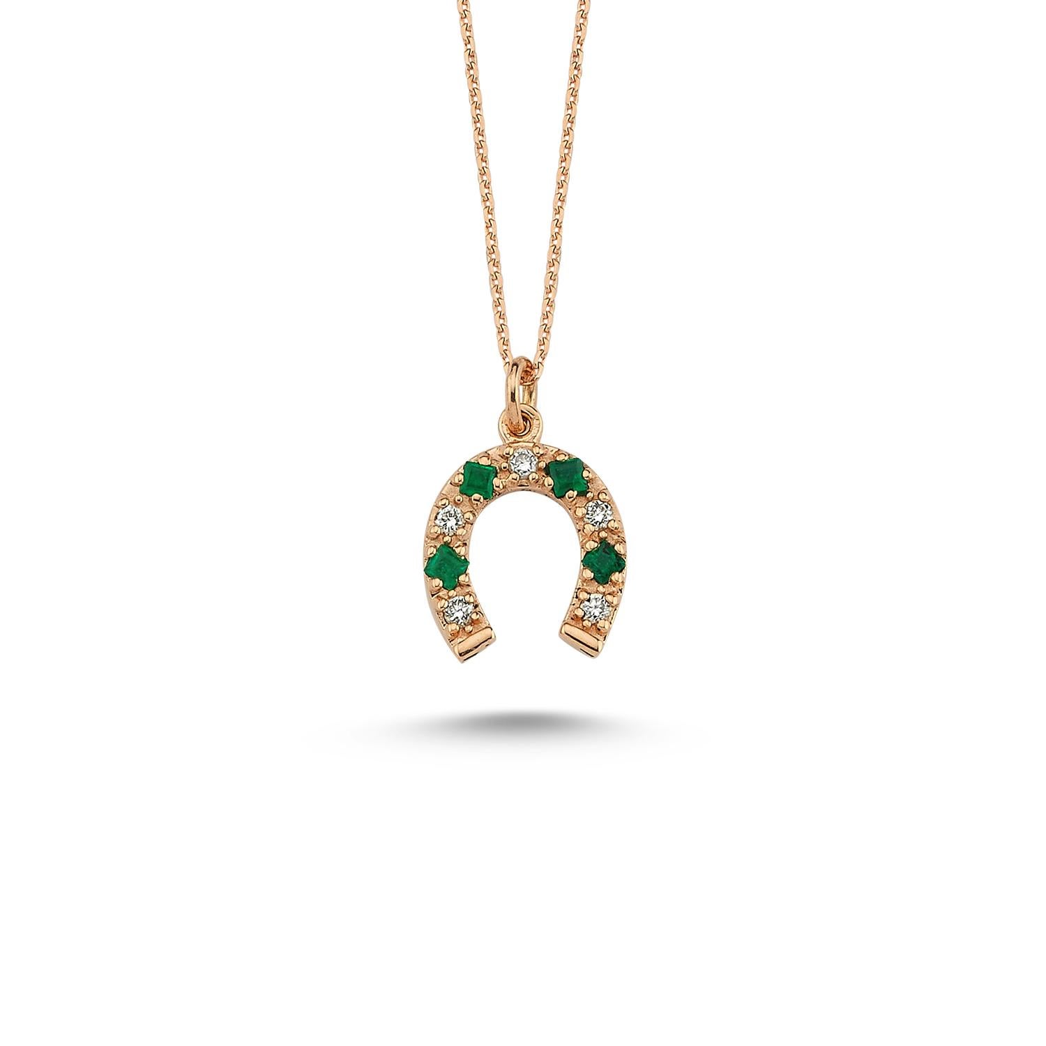 Horseshoe necklace in 14k rose gold with 0.06ct white diamond by Selda Jewellery

Additional Information:-
Collection: Art of giving collection
14K Rose gold
0.06ct White diamond
0.07ct Emerald
Pendant height 1cm
Chain length 42cm