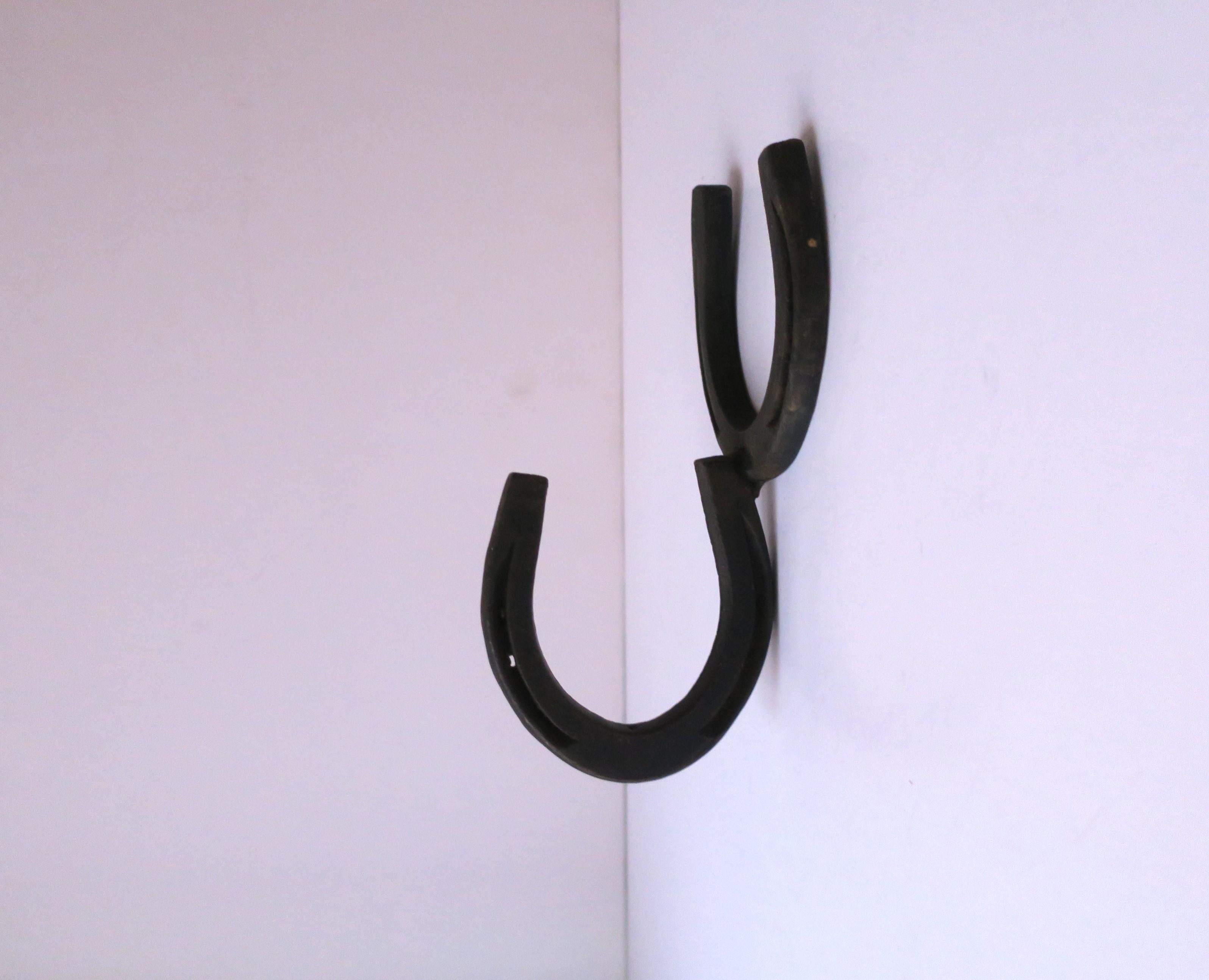 A steel pony horseshoe wall hook, circa early-20th century., USA. A great piece for a barn, kitchen, foyer, mud room, residential or commercial projects/hotel, etc. Dimensions: 3.25