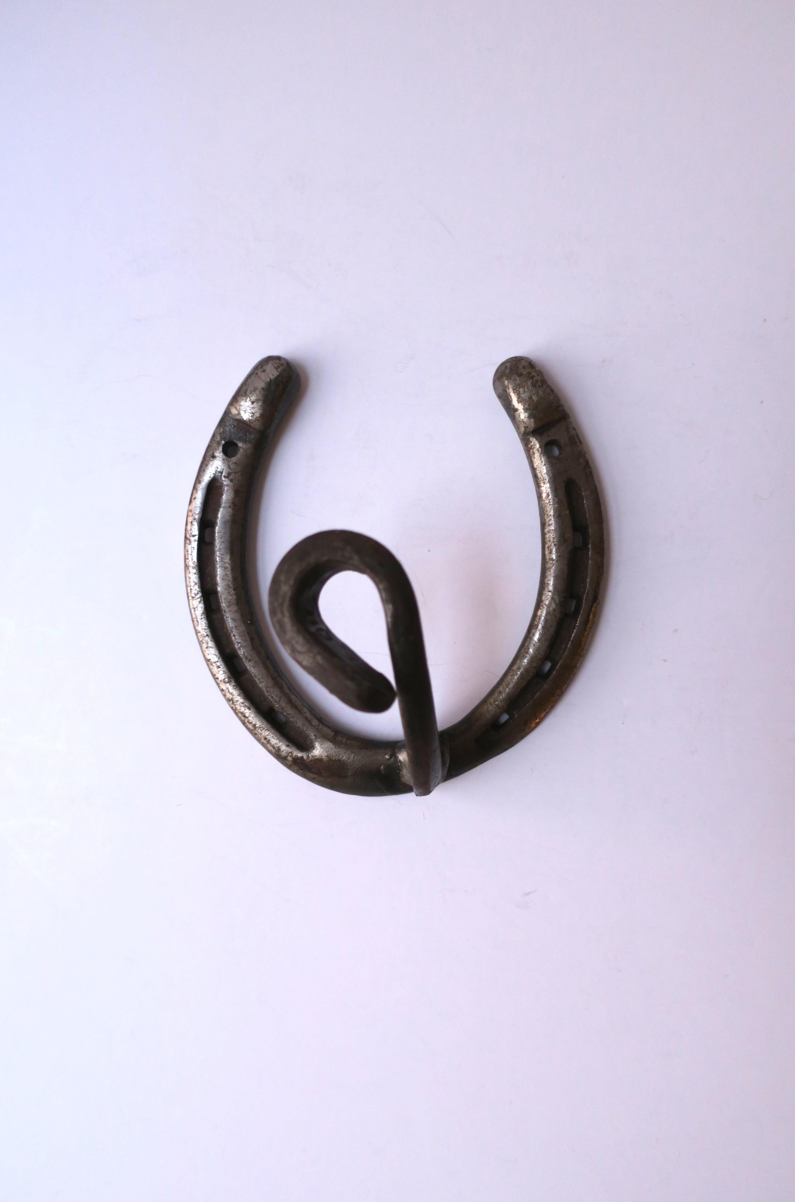 A substantial steel horseshoe wall hook, circa early to mid-20th century., USA. A great piece for a barn, kitchen, foyer, mud room, residential or commercial projects/hotel, etc. Dimensions: 3