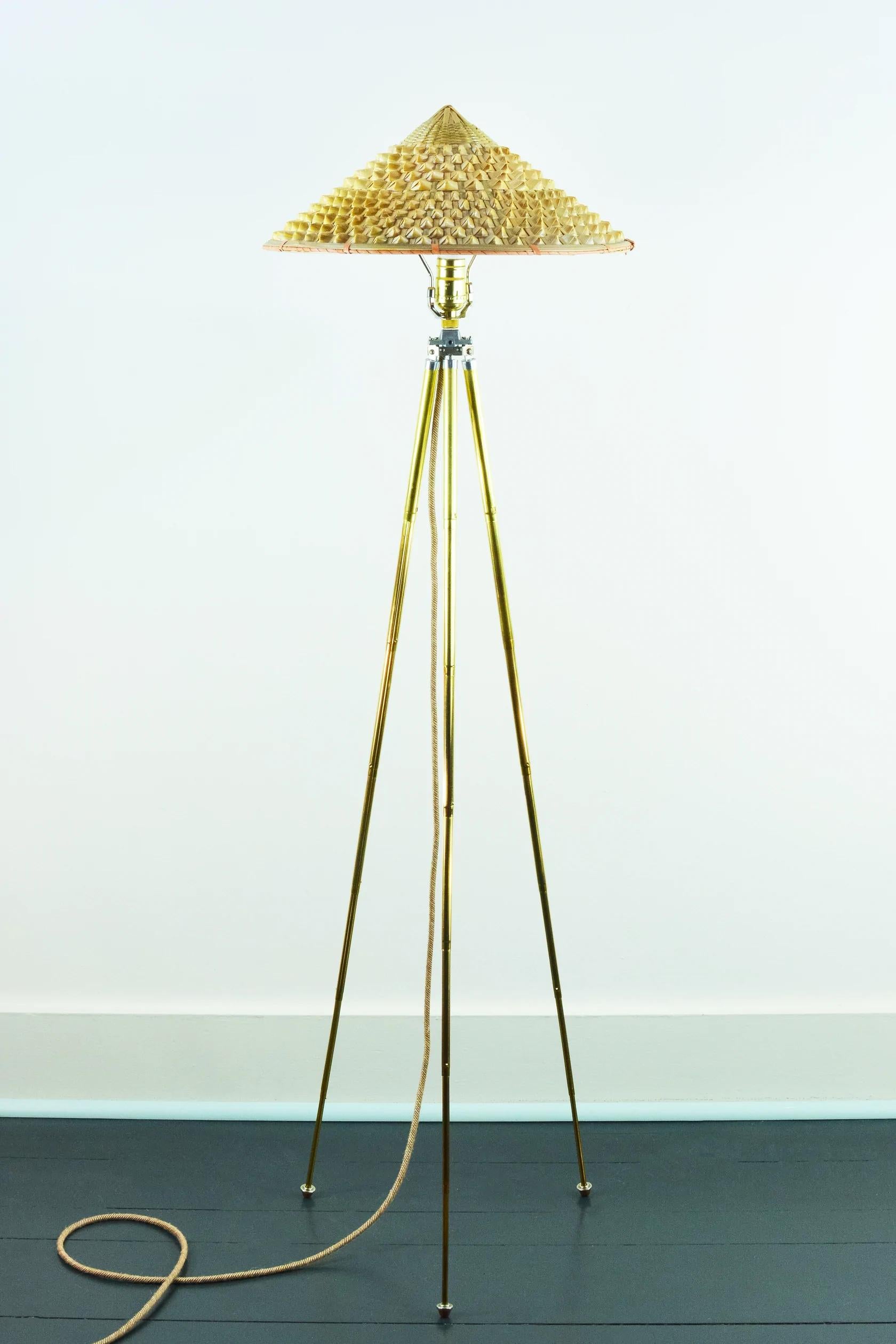 The 'Horst' adjustable brass tripod floor lamp collection was inspired by the life and times of globe-trotting early 20th century lensman Horst P. Horst, who introduced color photography to a mass audience through his genre-defining fashion shoots