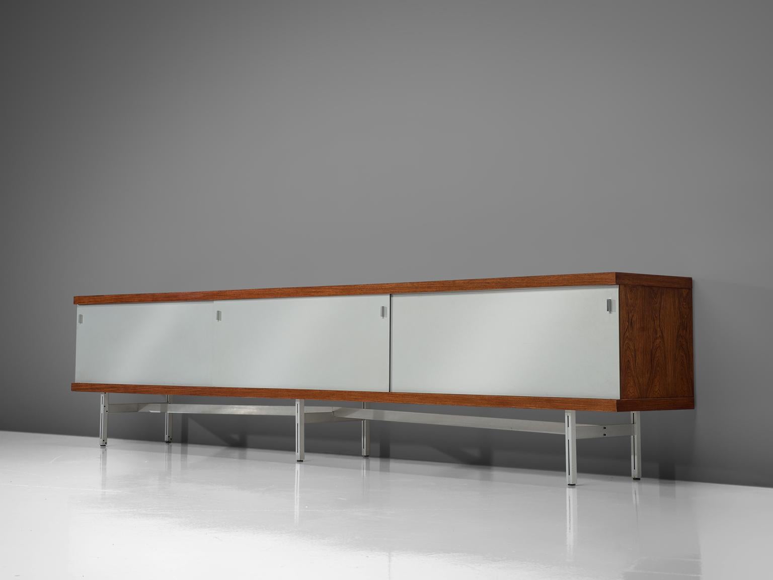Horst Brüning for Behr, credenza, off white to grey plywood, rosewood, metal, Germany, 1960.

This simplistic geometric credenza holds a rosewood case and a brushed metal frame. The sliding doors are made of white formica and have geometric grips.