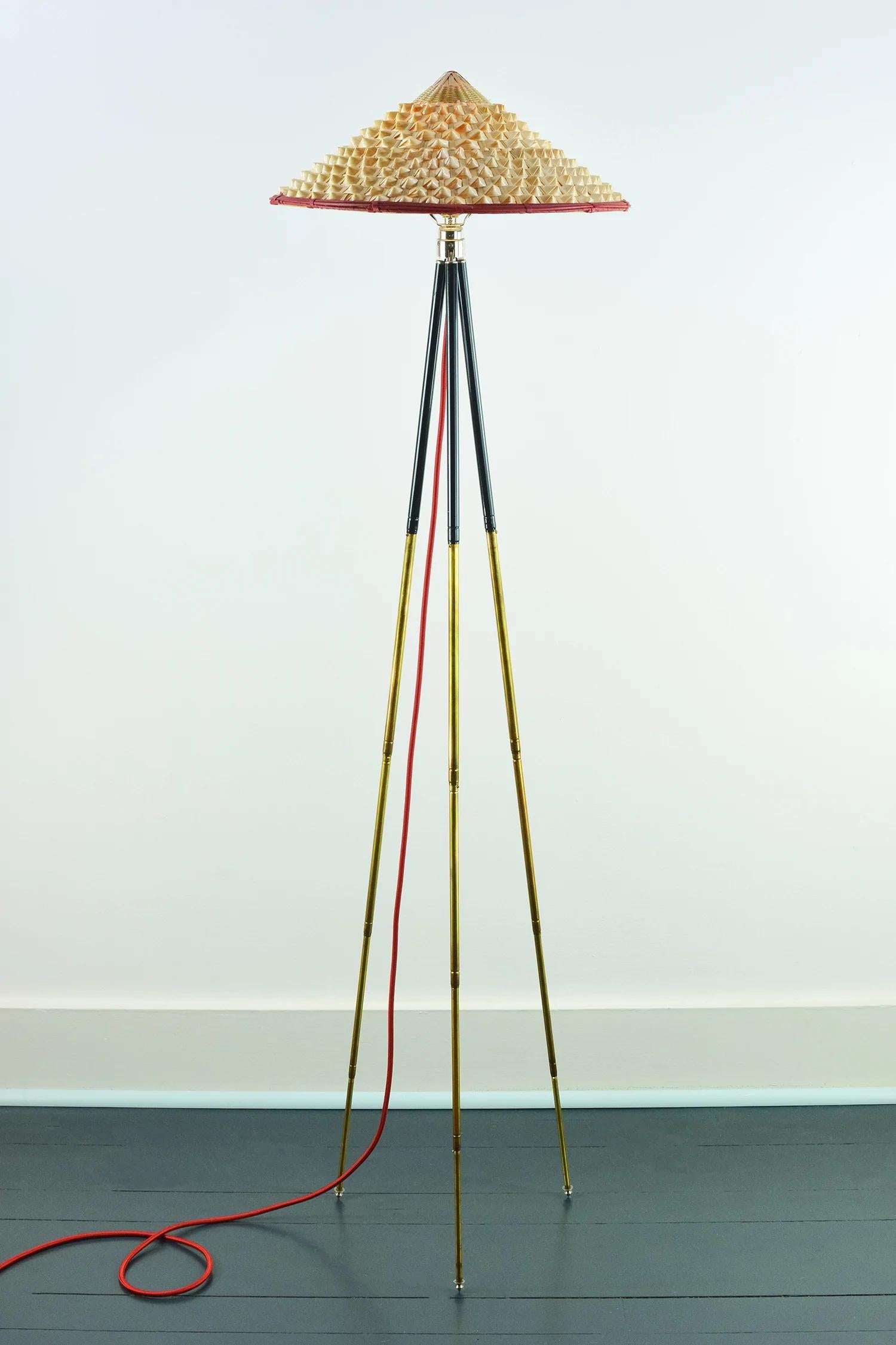 The Horst adjustable brass tripod floor lamp collection was inspired by the life and times of globe-trotting early 20th century lensman Horst P. Horst, who introduced color photography to a mass audience through his genre-defining fashion shoots for