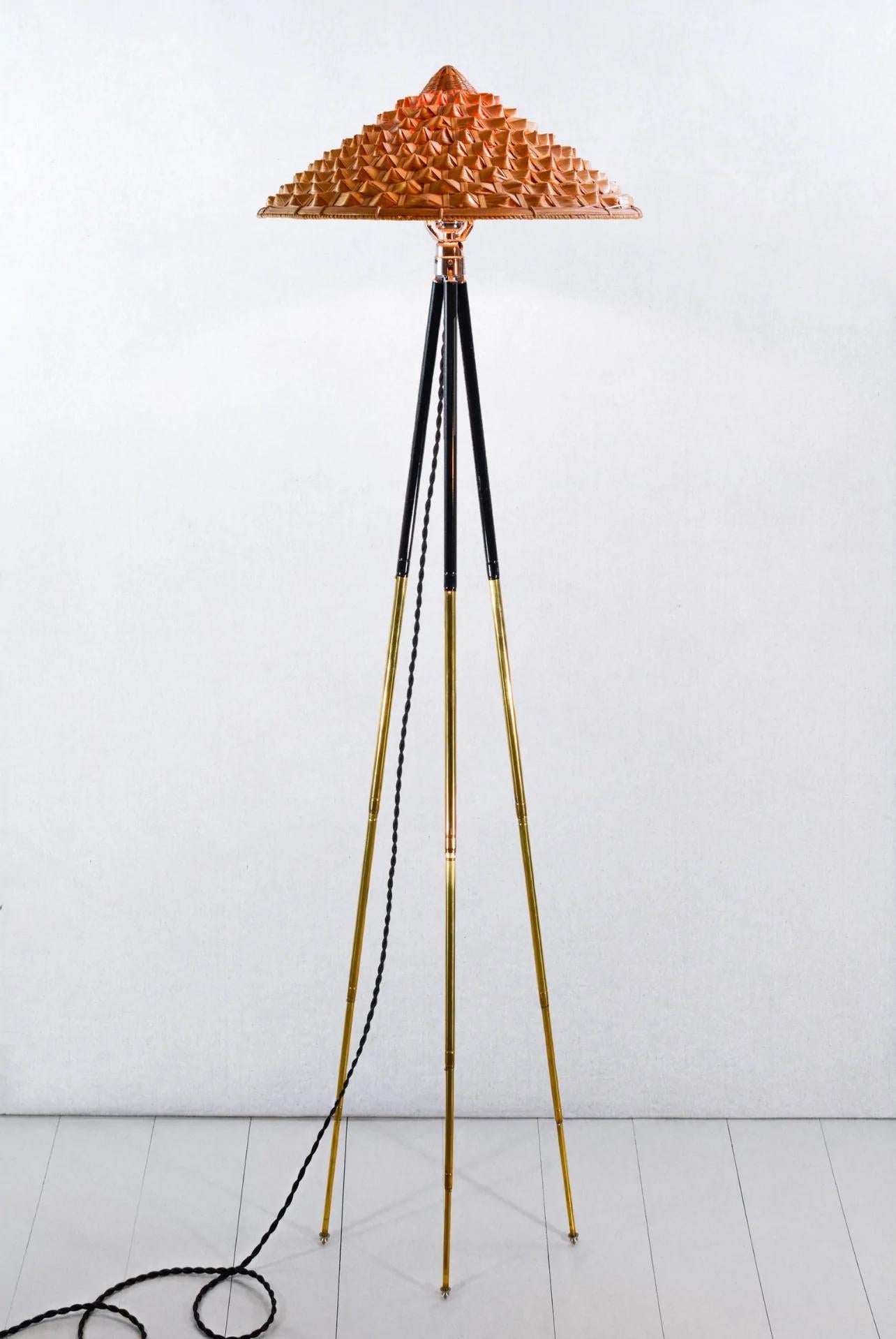 The Horst adjustable brass tripod floor lamp collection was inspired by the life and times of globe-trotting early 20th century lensman Horst P. Horst, who introduced color photography to a mass audience through his genre-defining fashion shoots for