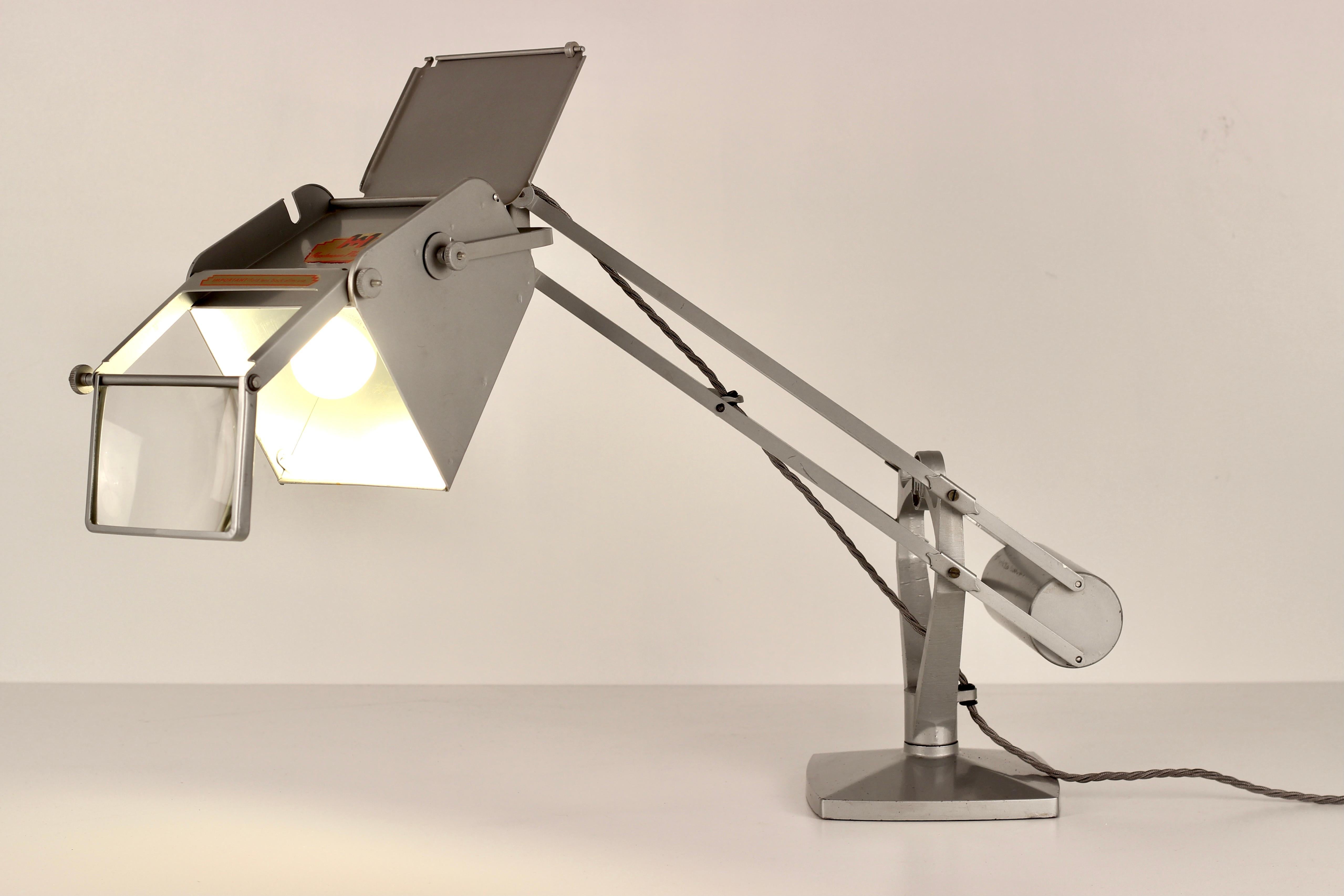 anglepoise lamp with magnifying glass
