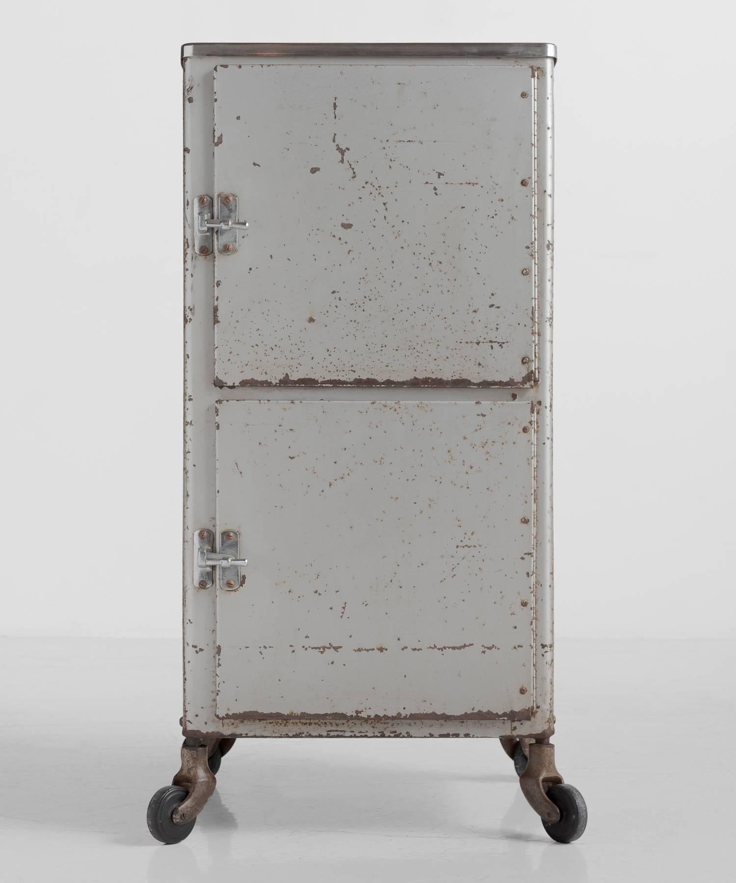 Hospital bedside cabinet, England, circa 1950

Pressed steel cabinet with chrome plate top and original worn and rusted exterior.