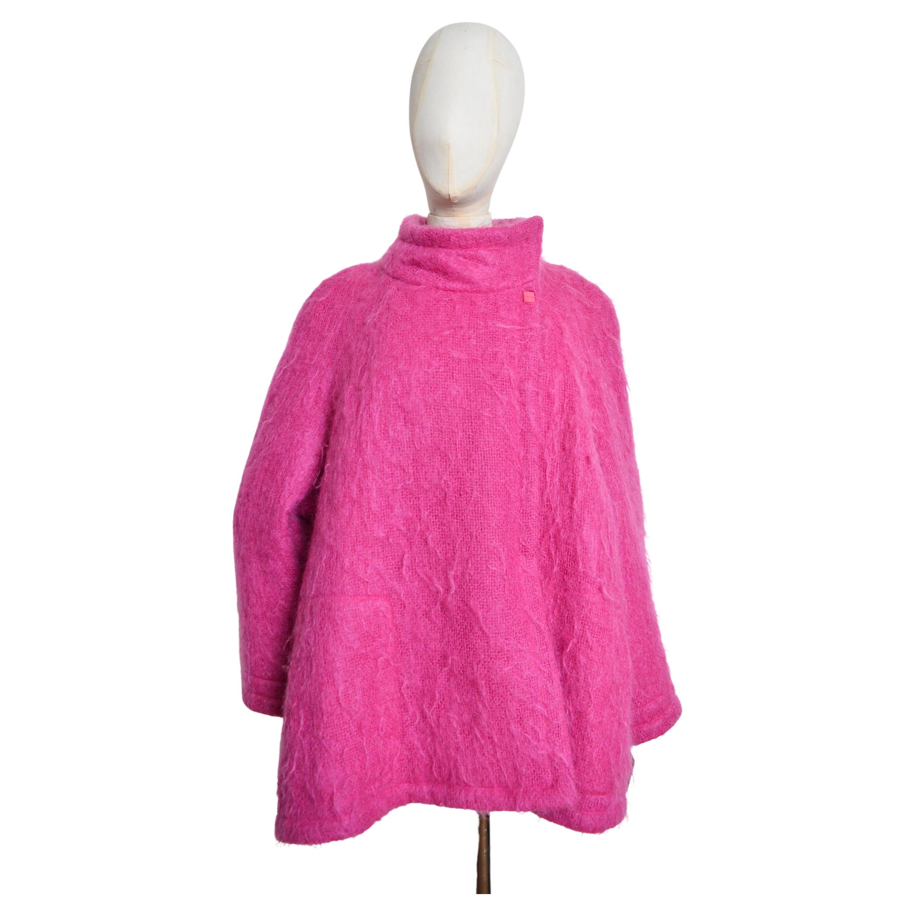 Beautiful Vintage Thierry Mugler, wool swing coat made from soft fuzzy 'hot pink' coloured mohair, circa 1980. 

This beautiful swing coat features an oversized fit with an asymmetric collar button fasten, smooth hot pink satin interior lining and