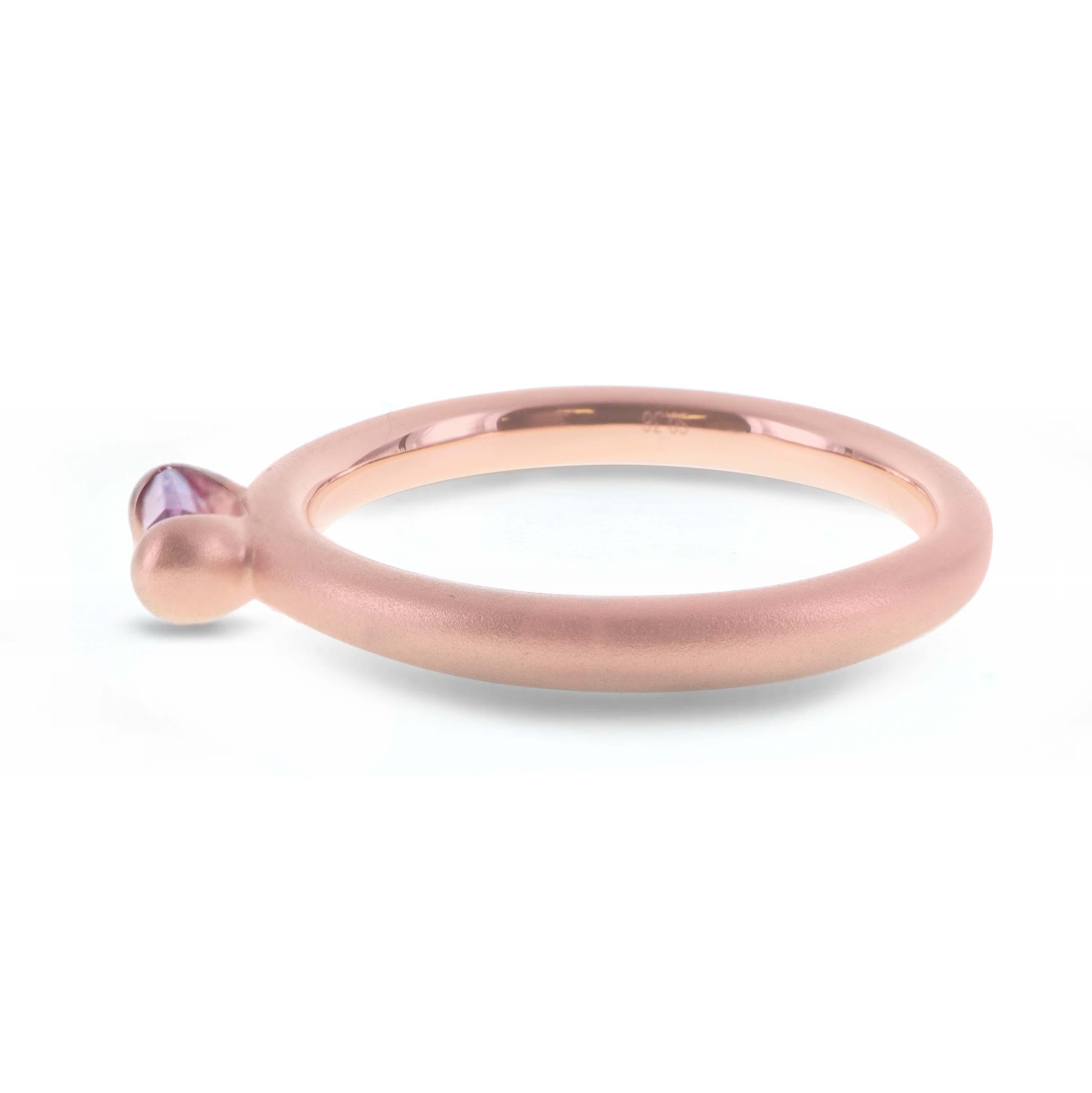 0.36 carat of super saturated hot pink sapphire is set in this 18K matt finish gold ring. The ring is hand made in Hong Kong and the gold weighs 3.89 grams. The ring can be worn as a trio ring or can be worn individually. 