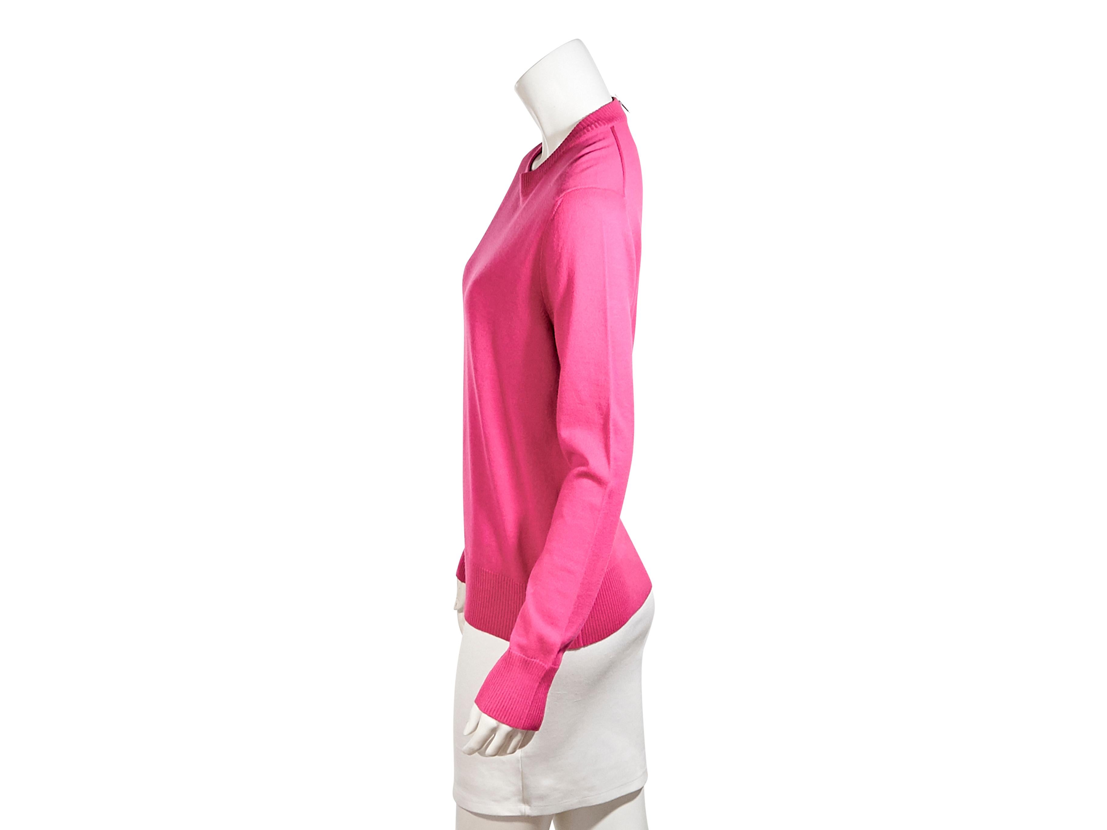 Product details:  Hot pink wool sweater by Gucci.  Long sleeves.  Roundneck.  Ribbed trim.  Quarter back-zip closure.  Pullover style.  Silvertone hardware.  38