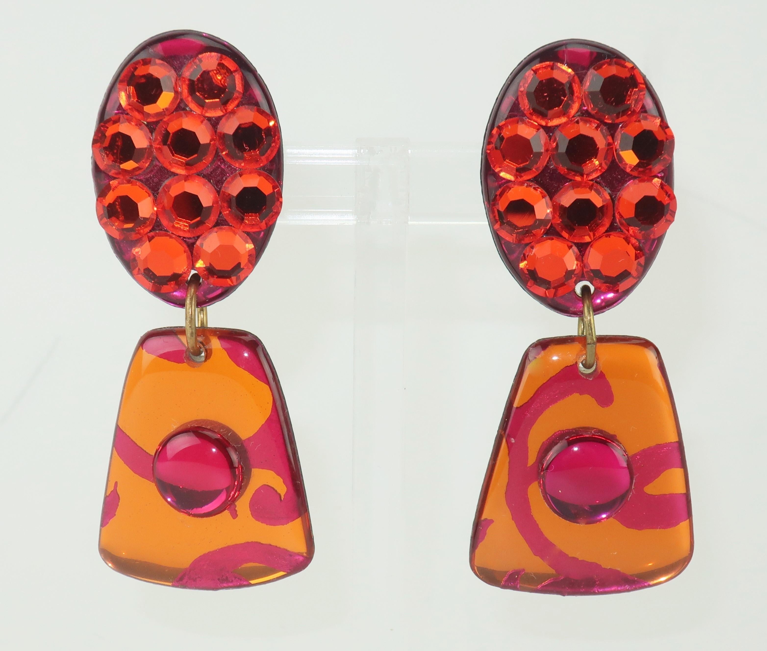 1980's hot pink and orange pave crystal clip on dangle earrings with a fun and frivolous look perfect for a pop of sparkle and color.  No maker’s mark.
CONDITION
Good to fair condition with an abrasion at the back of one earring shown in photograph