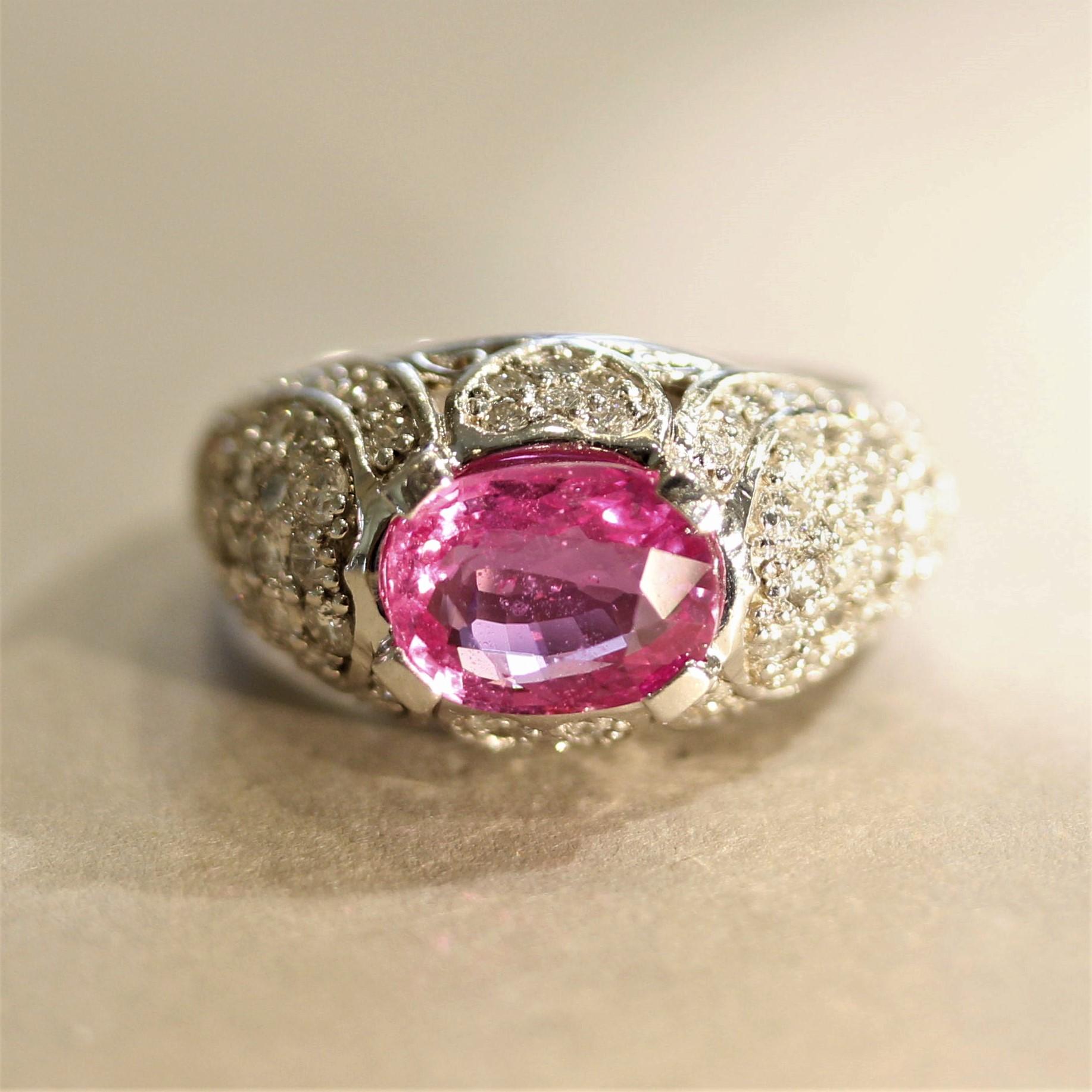 A very fine pink sapphire takes center stage! It weighs 3.02 carats and has a vivid hot-pink color with excellent brilliance and clarity. It is accented by 1.66 carats of round brilliant-cut diamonds which are set in the gallery of the ring which
