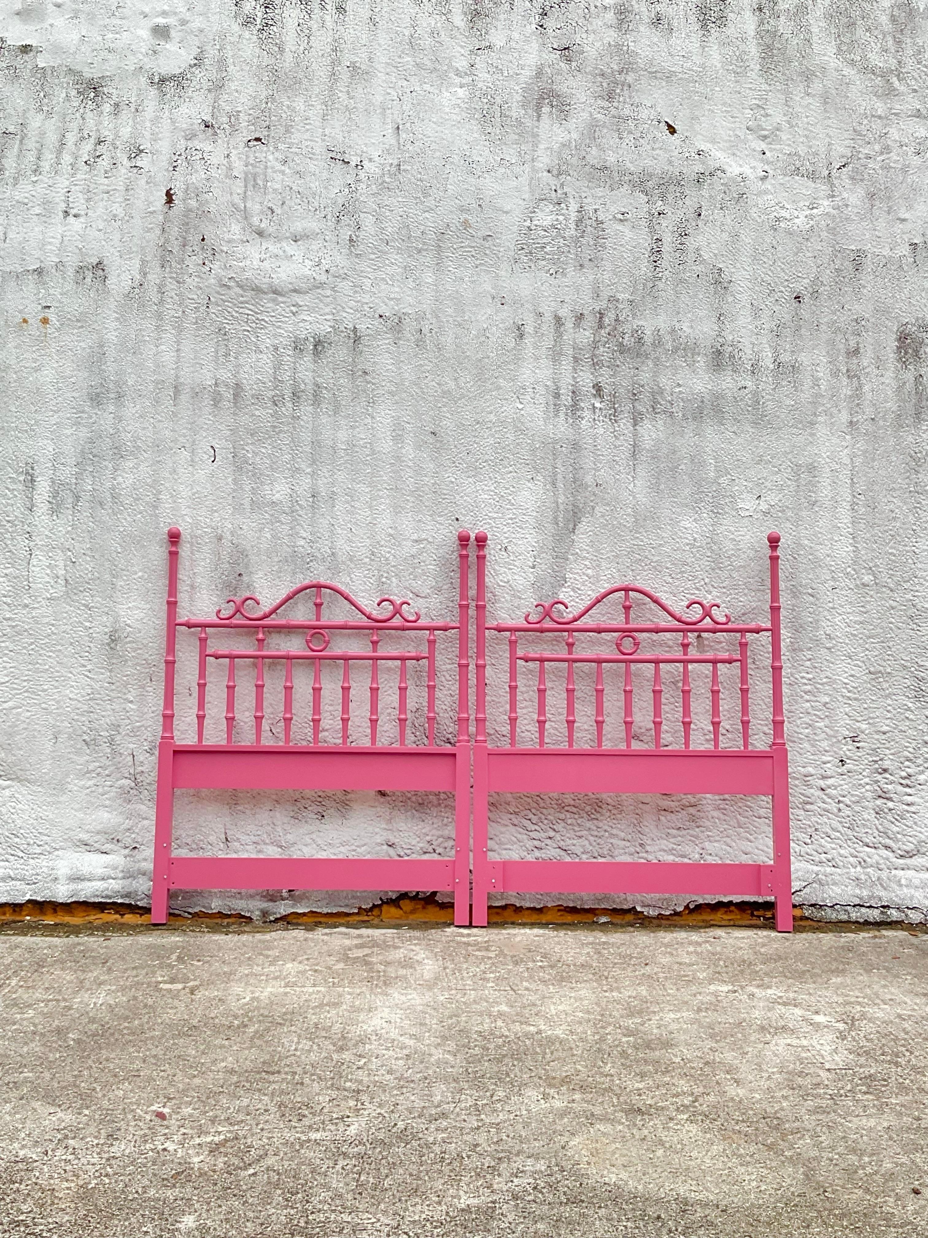 A not only gorgeous but also unique pair of vintage headboards made of wood. The wood is made to look like bamboo in an intricate design and painted in a bright shade of hot pink. Add a fun pop of color to any guest suite. Acquired at a Palm Beach