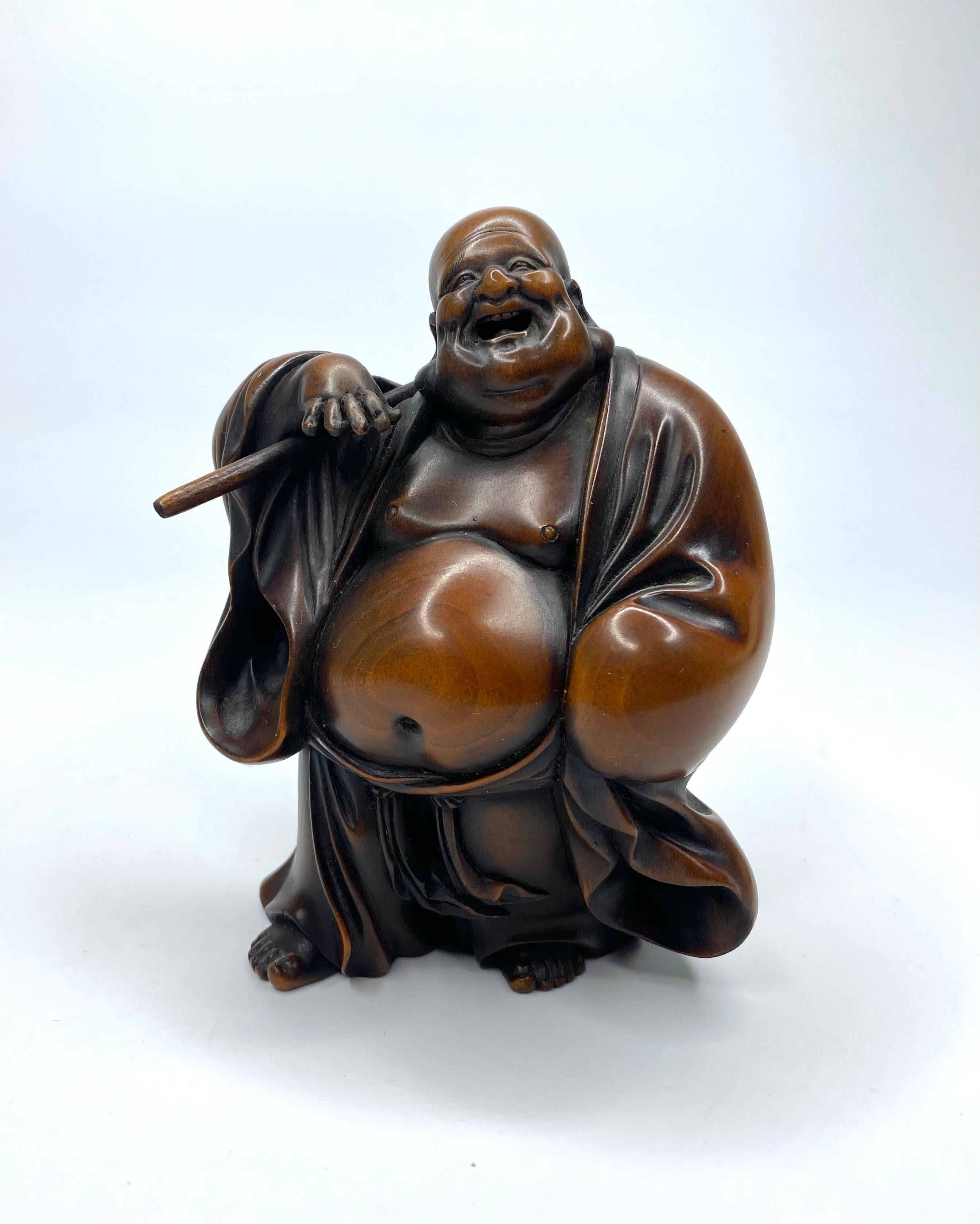 Hotei, a carved boxwood okimono, signed, Meiji Period. 4