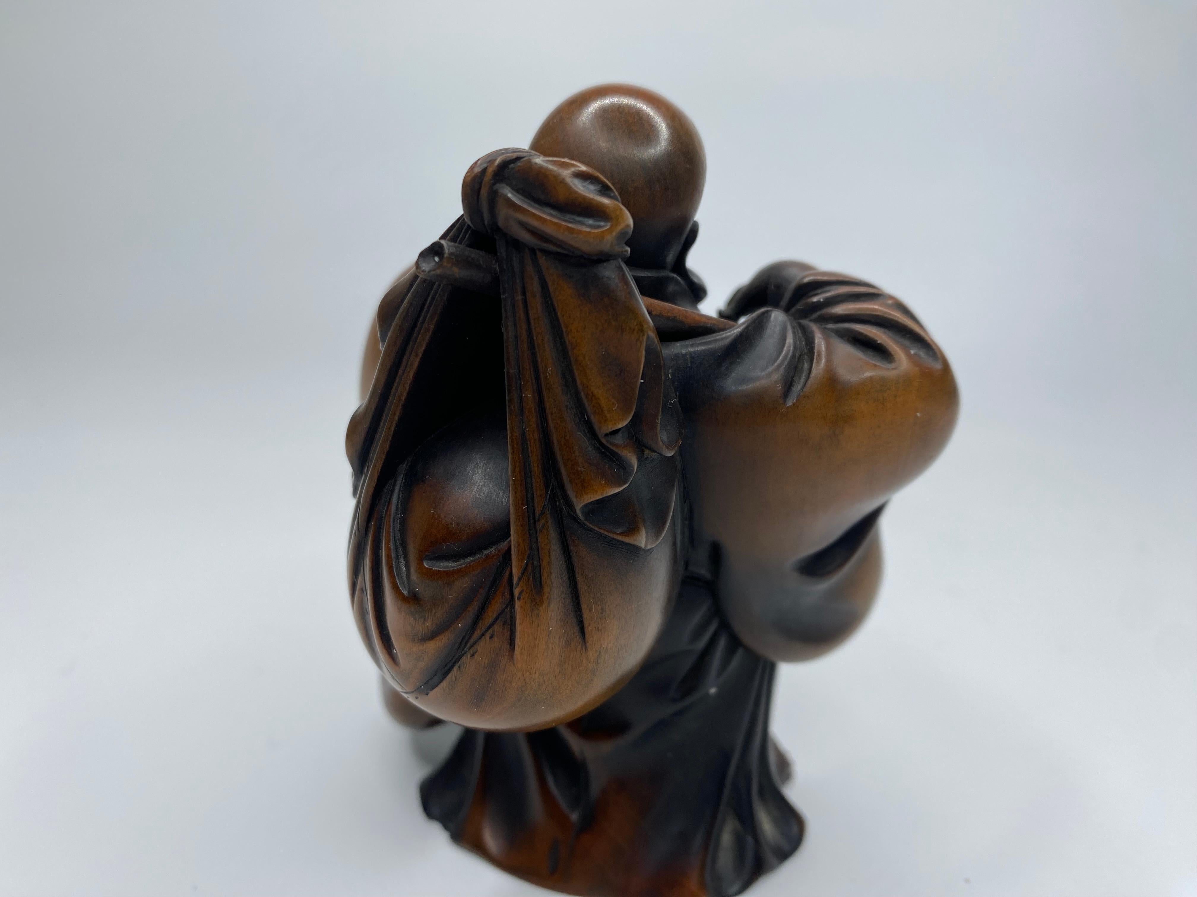 Hotei, a carved boxwood okimono, signed, Meiji Period. 5