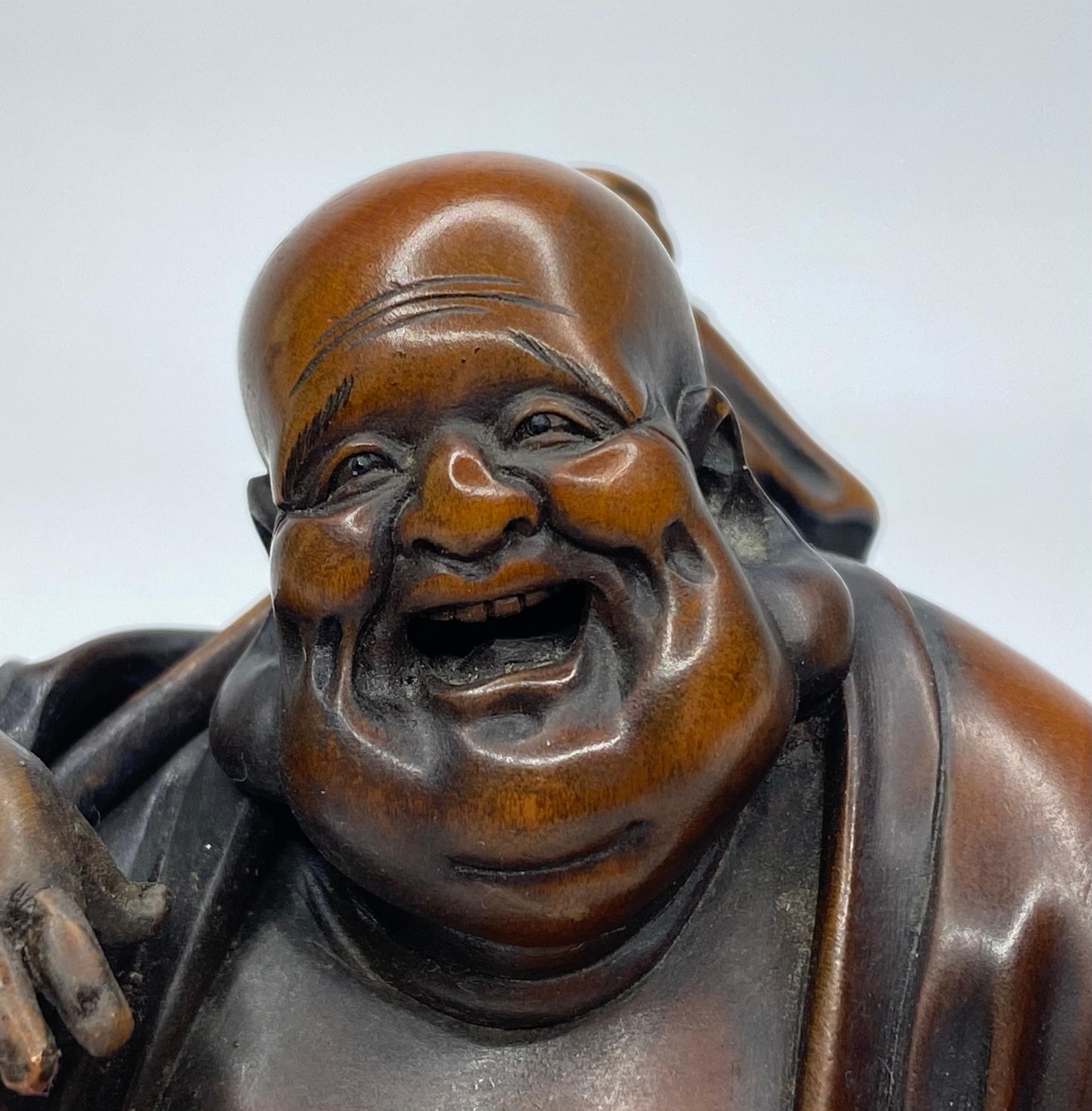 Boxwood Hotei, a carved boxwood okimono, signed, Meiji Period.