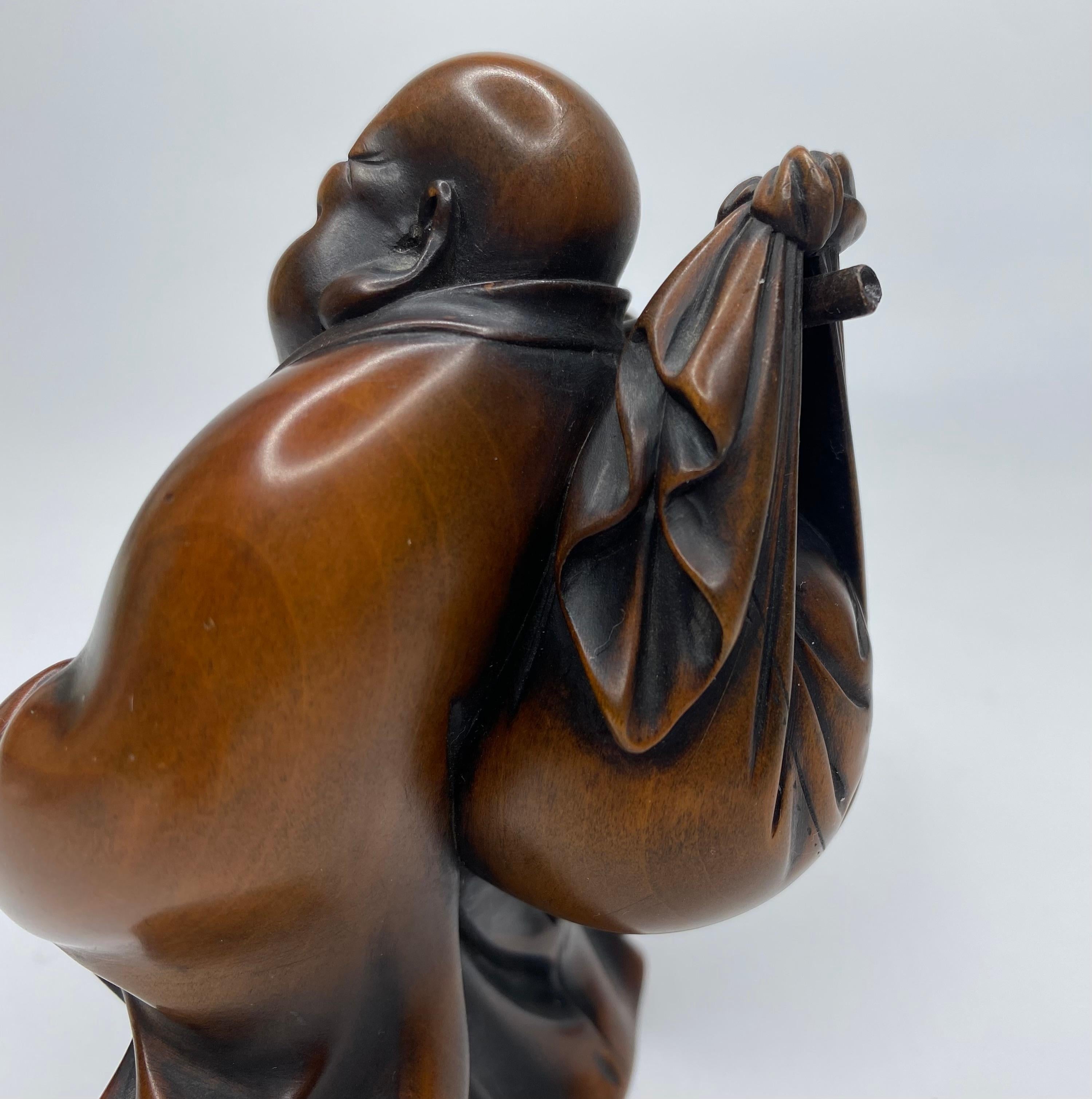 Hotei, a carved boxwood okimono, signed, Meiji Period. 2
