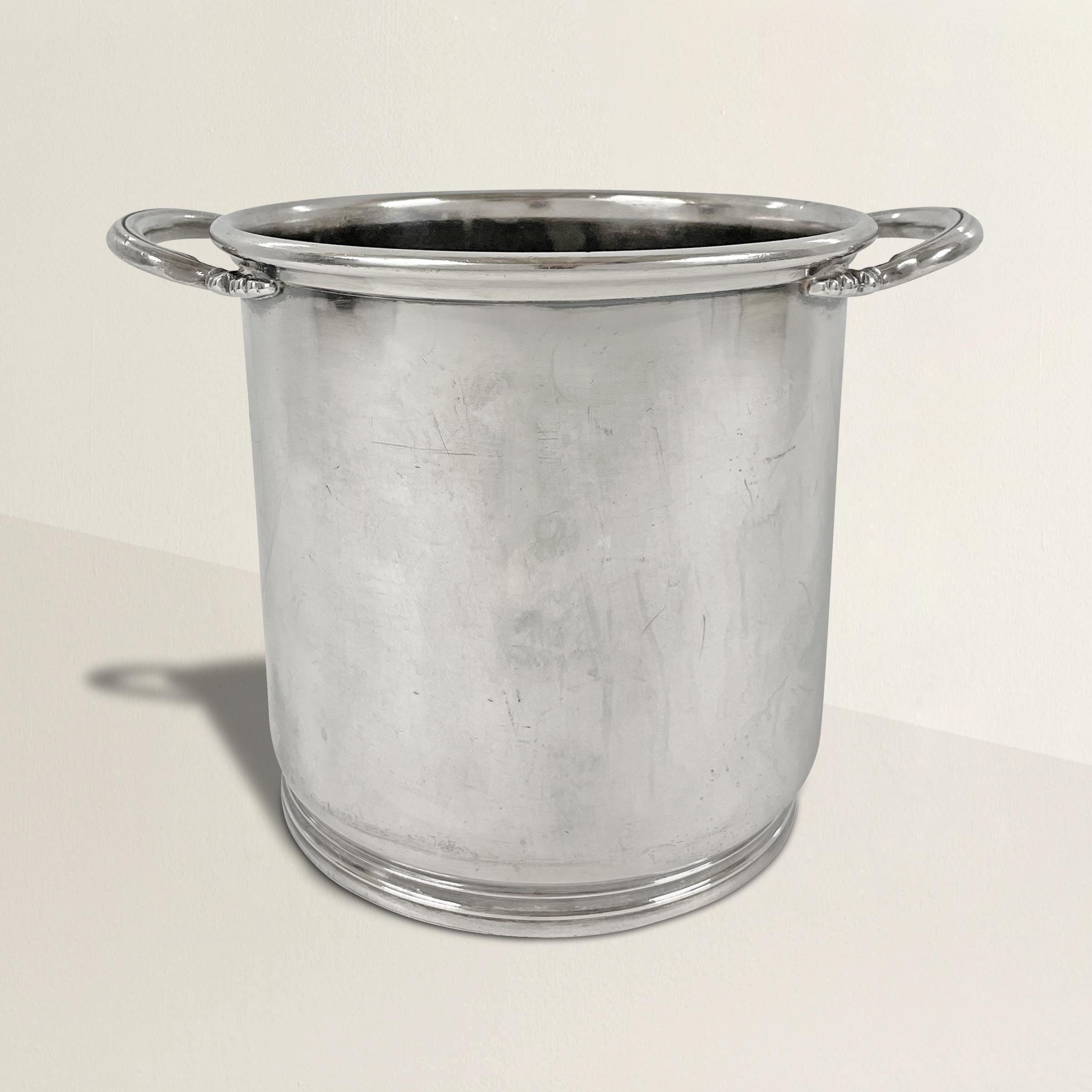 A wonderful vintage hotel silver champagne ice bucket with a chic form with two handles, straight sides, and a simple foot. Marked, 