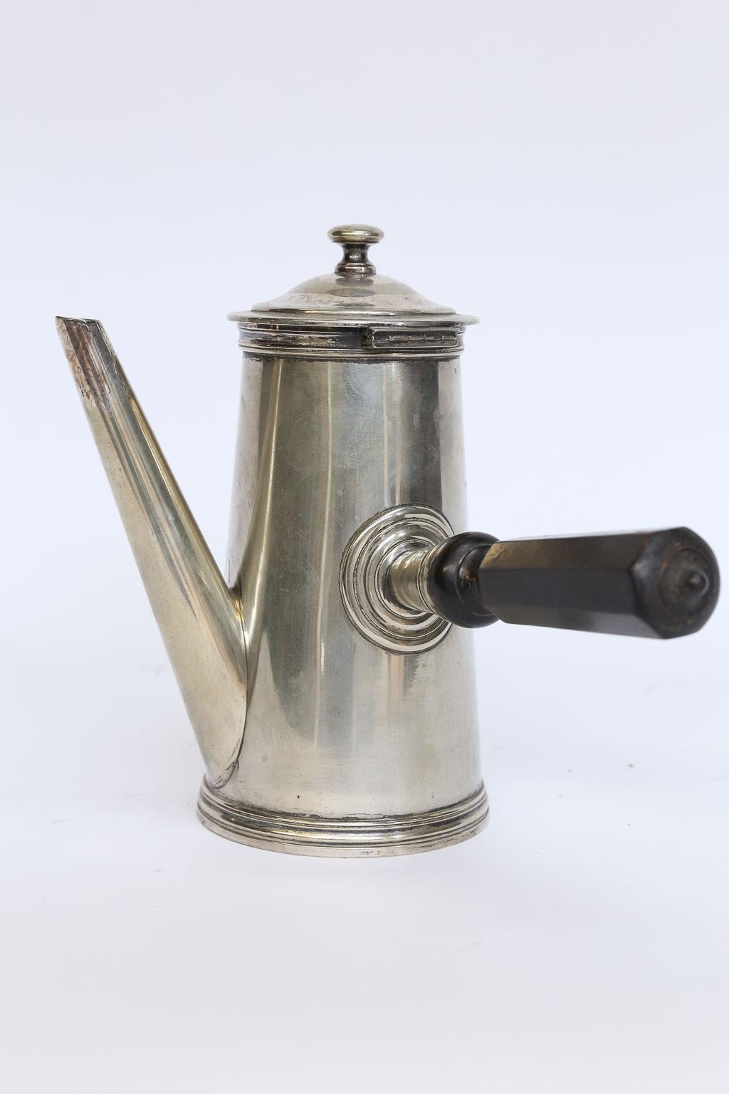 Found in France, this late 19th century hotel silver chocolate has a hinged top and wood handle to keep hands cool while serving hot chocolate. Marked on the bottom with the numbers 10 72794 and 3 hallmarks.