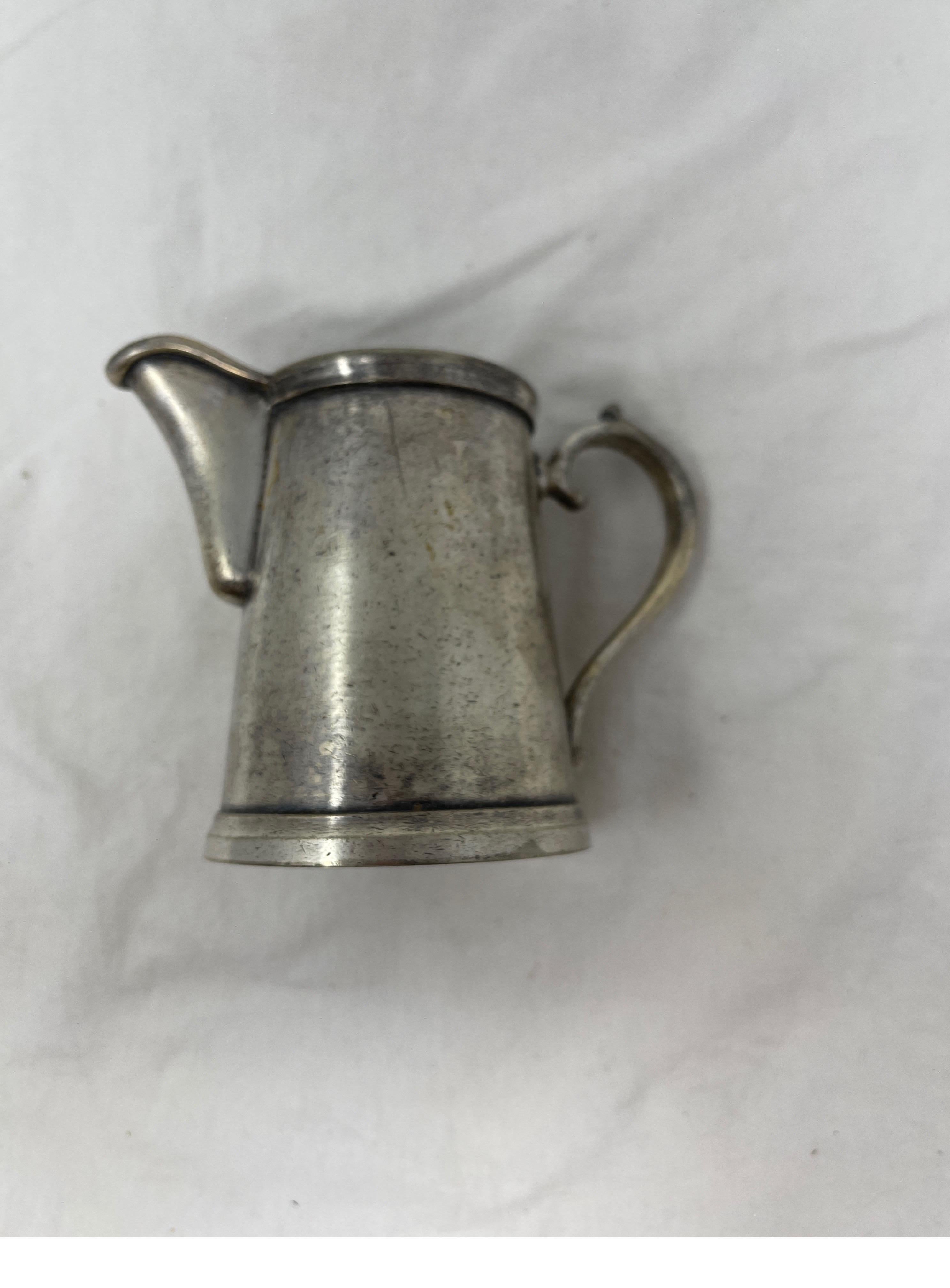 Make your coffee or tea time a luxury experience with this adorable Hotel Silver creamer. This beautiful piece can be used for what it was intended or make a lovely pencil/pen holder for a desk.

Measures: 2 3/8