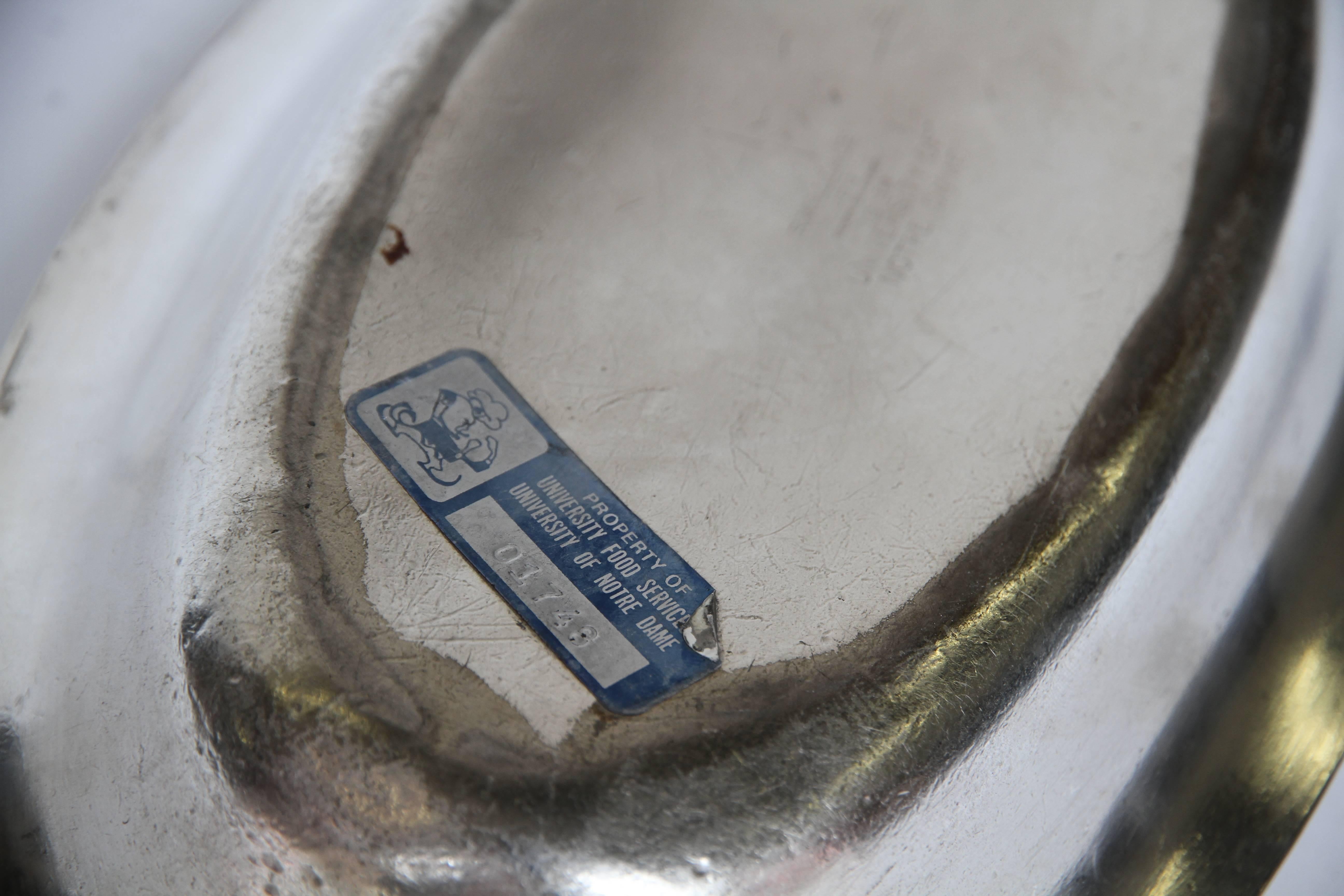 A silver soldered bowl made by R Wallace for the University of Notre Dame. With a classic shape these pieces were made extra dense and heavy so as not to spill when in use. Marked R WALLACE, 050, Sliver Soldered, 12 IN, University of Notre Dame. A