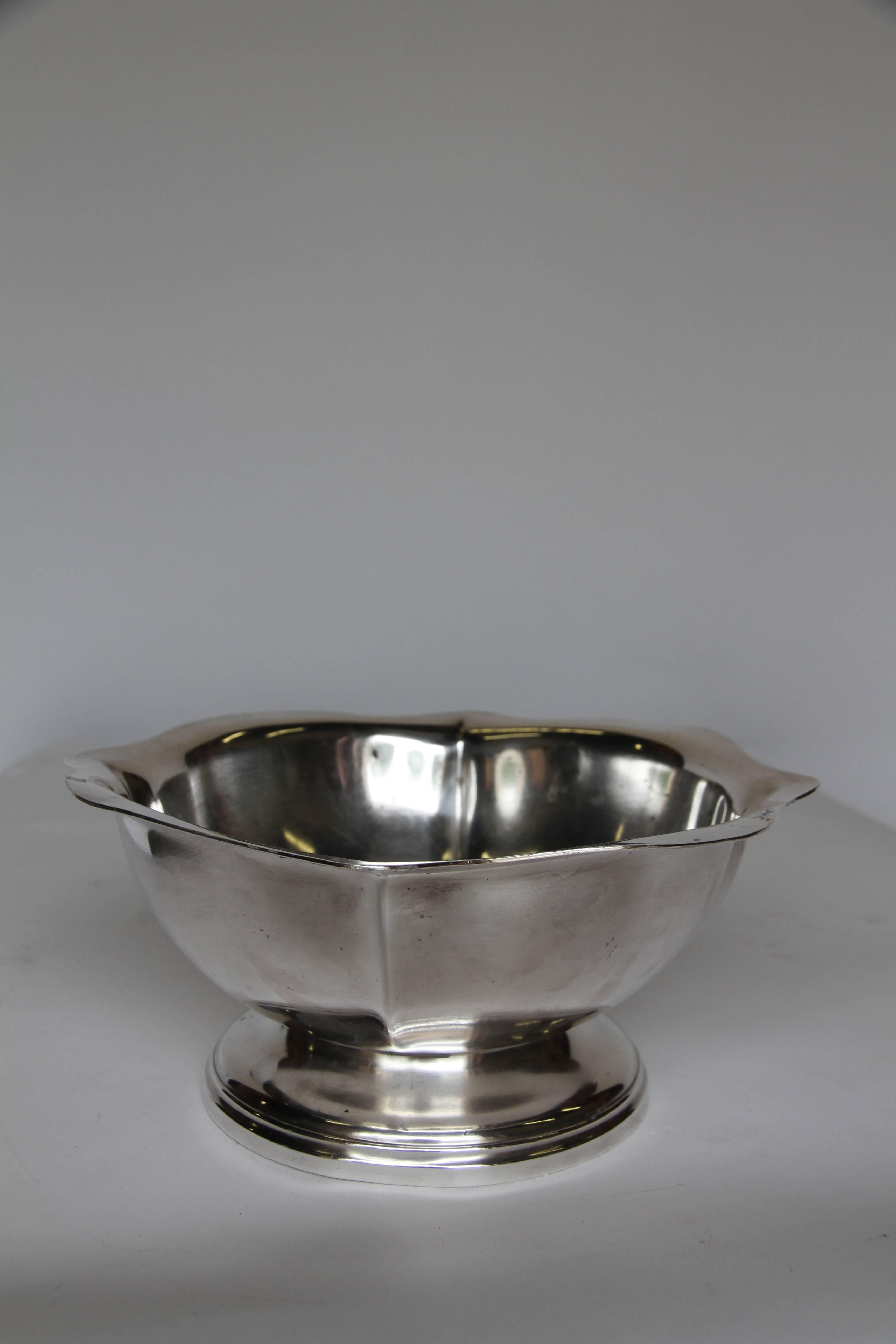 A World War II era silver soldered serving bowl made by Reed and Barton for the US Navy. These pieces were made extra dense and heavy so as not to spill when the ship was under sail. Marked Reed & Barton 3610, along with a mark showing a parachute,