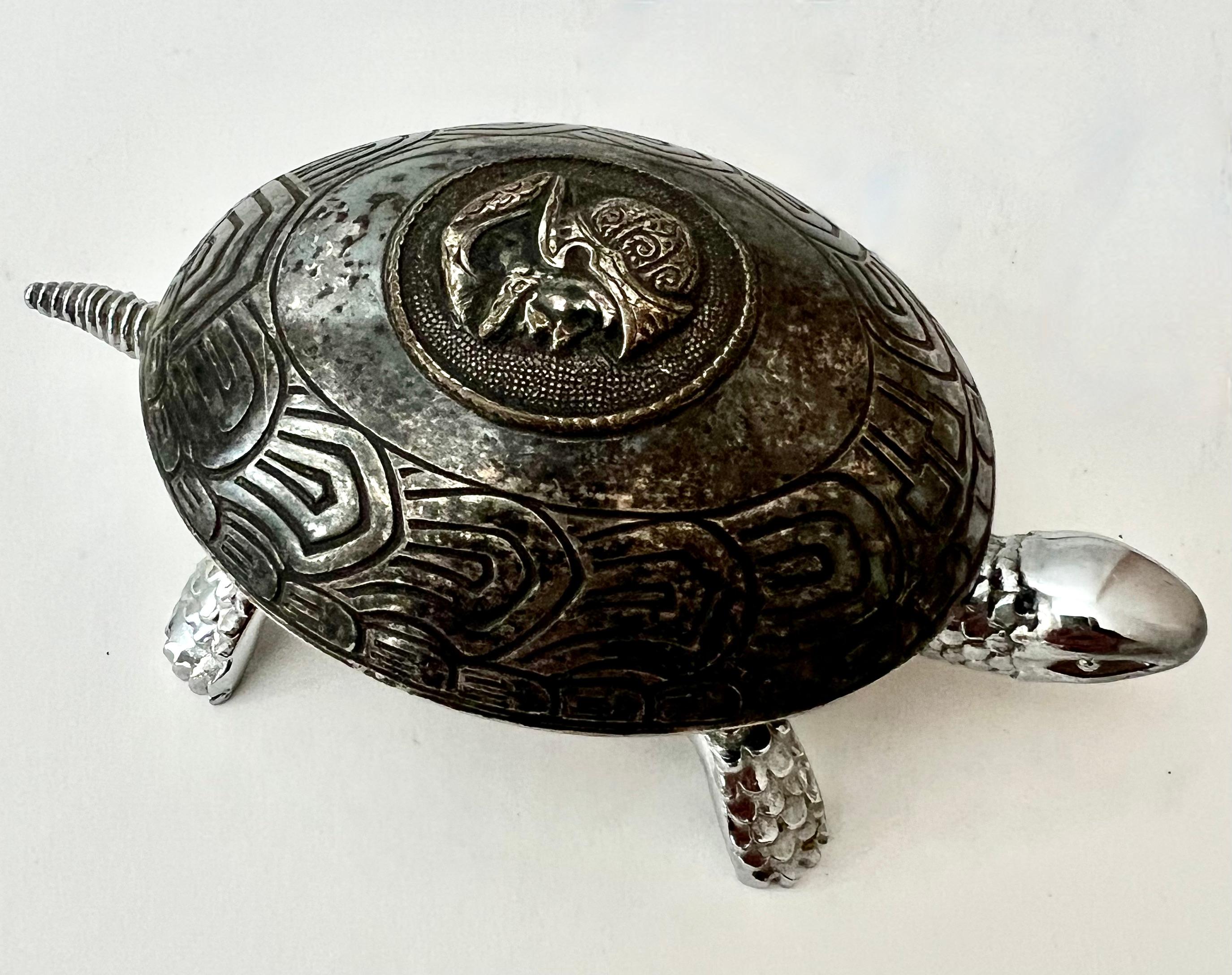 A delightful turtle - decorative when resting, however the piece winds and, after winding, when the tail or head are pressed a bell rings - a compliment to many spaces. As a decorative piece, in any room. 

Also, perfect for a commercial space