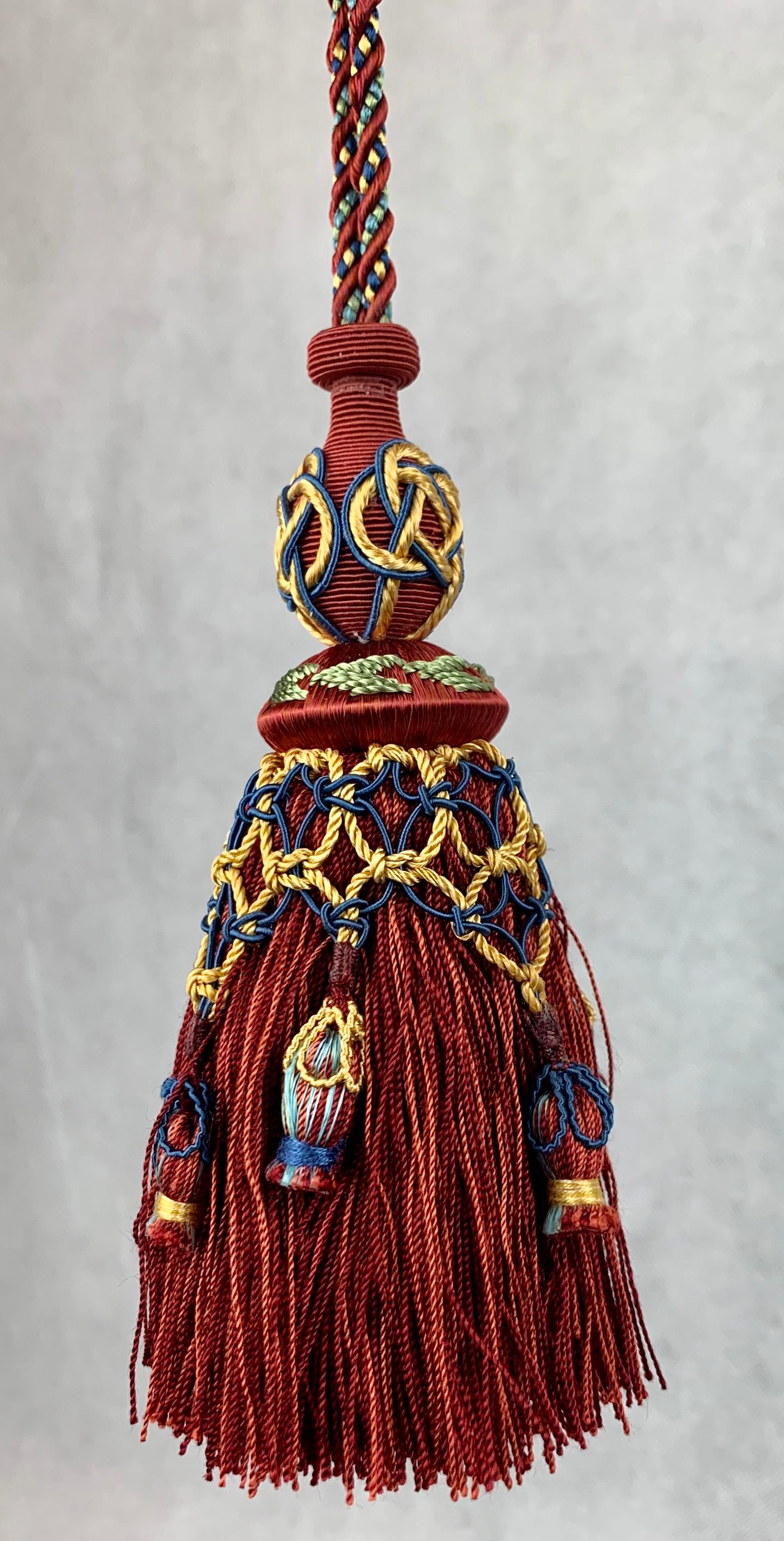 Houlés of Paris passementerie gland cle (key tassel) in Rouge. Nobody makes tassels like Houles.  This never used tassel still is rich in color. Perfect to hang on the key of a piece of furniture. If you don't have a key hang it from a nob or