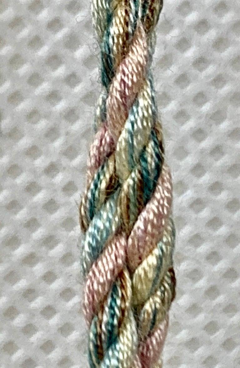 Houlés of Paris passementerie key tassel in Peach. Nobody makes tassels like Houlés. They are the oldest passementerie house still in family hands. This never used tassel still is rich in color. Perfect to hang on the key of a large piece of