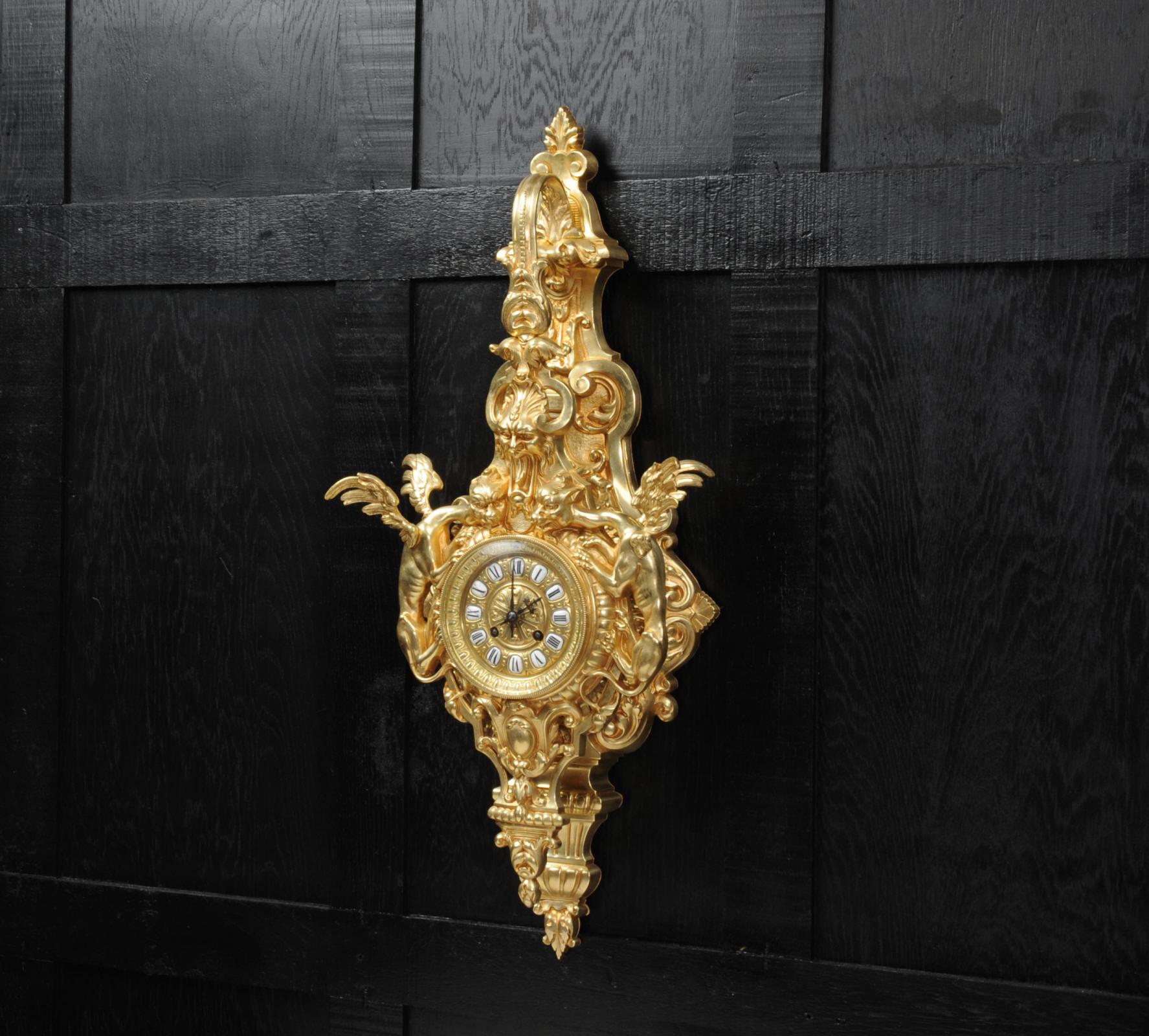 A wonderful and rare Gothic Cartel clock, circa 1870, beautifully modelled in gilt bronze. Chronos the god of time holds the clock from a bracket while the winged hounds of the devil creep up on the clock or time itself. The dial is also gilt bronze
