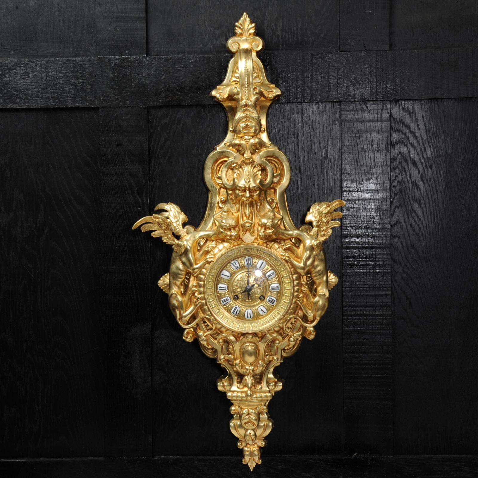 A wonderful and rare Gothic cartel clock, beautifully modelled in gilt bronze dating from around 1870. Chronos the god of time holds the clock from a bracket while the winged hounds of the devil creep up on the clock or time itself. The dial is also